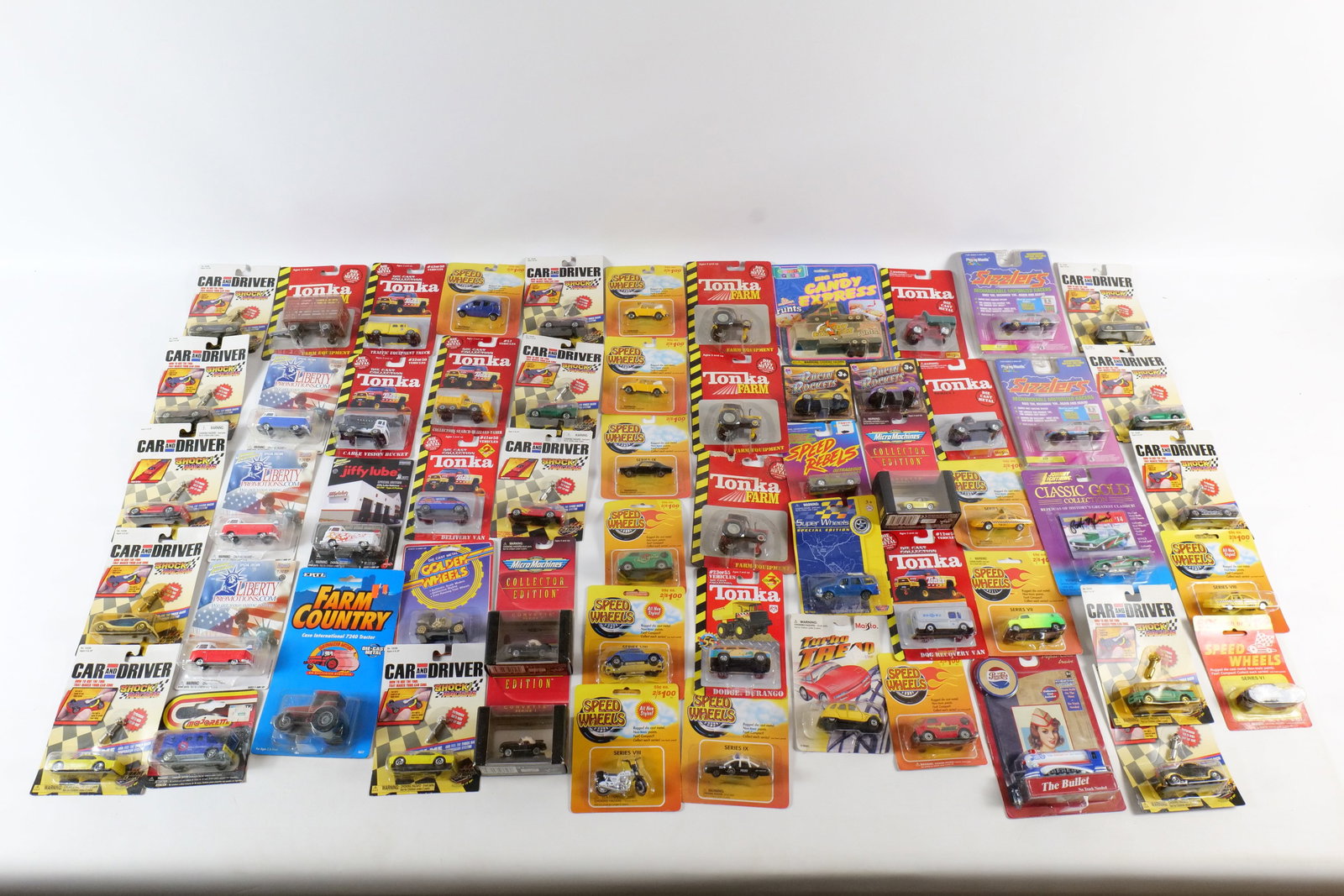 Group Lot of Diecast Cars: Group Lot of Diecast Cars. Various Brands including Johnny Lightning, Ertl, Tonka, Speed Wheels, Road Champs and Much More. All in package. Packaging has some wear. All invoices must be paid within 24