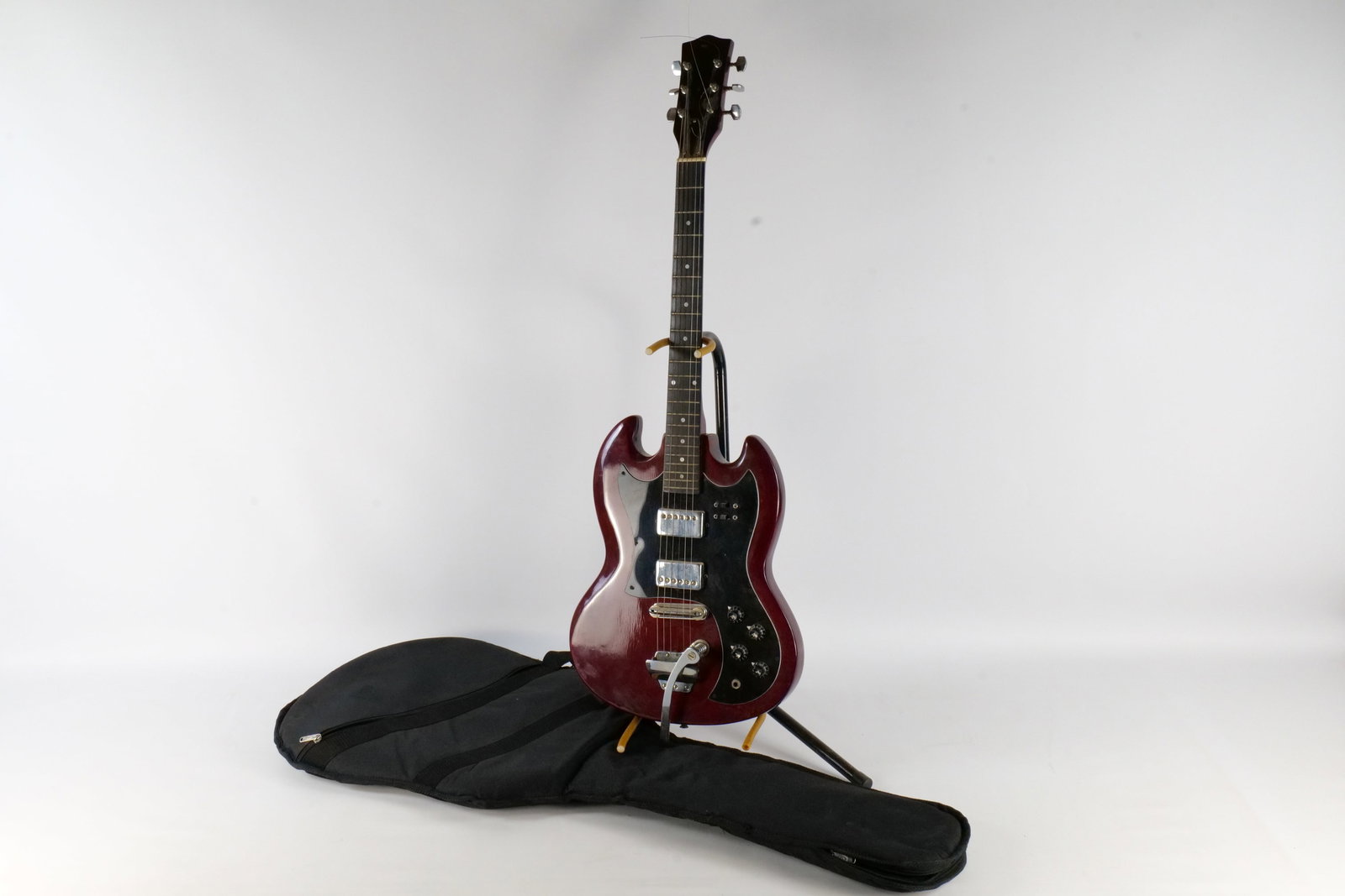 Vintage Late 1970's/1980's SG Style Electric Guitar: Vintage Late 1970's/1980's SG Style Electric Guitar - Cherry Red. Made in Korea. Lawsuit Era Design Traits. Equipped with 2 Vintage Humbucking Pickups. Includes 2 Volume, 2 Tone, 2 Rocker Switches, an