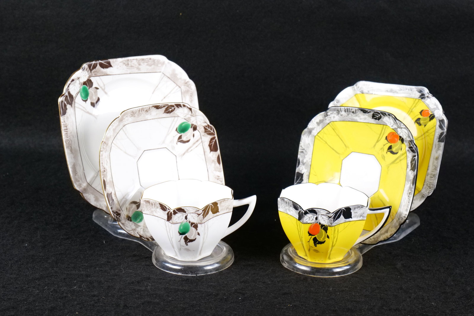 Lot of 2 Shelley Bone China "Damsons" Teacup Trios: Lot of 2 Shelley Bone China "Damsons" Teacup Trios. Both are Queen Anne Shaped with Octagonal Plates. Circa 1930's. One is Brown, Grey and Green and the other is Black, Yellow, and Orange. This Shelle