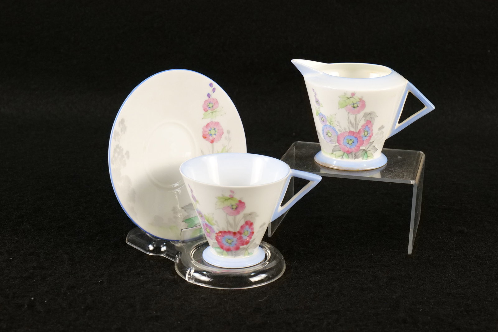 Shelley Hollyhocks Eve Shaped Teacup, Saucer and Creamer: Shelley Hollyhocks Eve Shaped Teacup, Saucer and Creamer. Pattern #12019. Circa 1932-1940. This Shelley Collection came from the Judy and Jerry Silverman Collection. Most of the collection was photogr