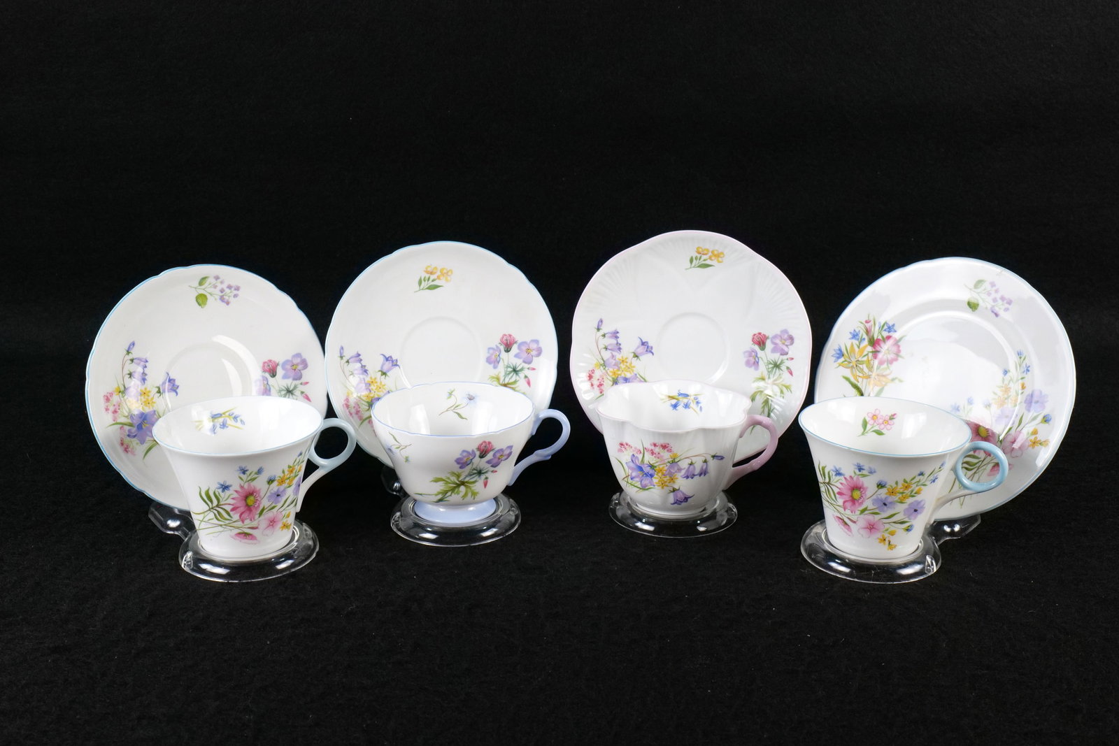 Lot of 4 Shelley Floral Tea Cup and Saucer/Under Plate Sets: Lot of 4 Shelley Floral Tea Cup and Saucer/Under Plate Sets. Including 2 x Regent Wild Flowers #13668 - One with Saucer and one with Underplate, Henley Wild Flower and Blue Rock #2328, and Dainty Unma