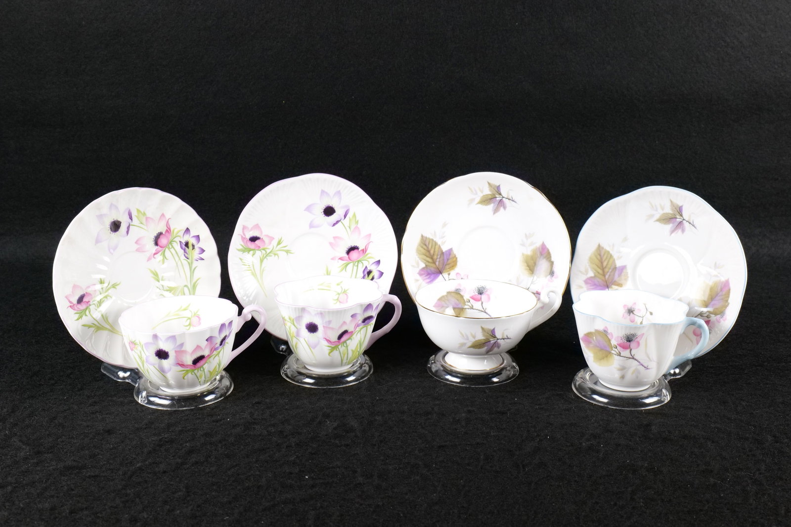 Lot of 4 Shelley Floral Teacup and Saucer Sets: Lot of 4 Shelley Floral Teacup and Saucer Sets. Including 2 x Wind Flower #14032 in Dainty and Ludlow and 2 x Floral with Leaves and Berries - Unmarked with Pattern # in Dainty and Gainsborough. This 