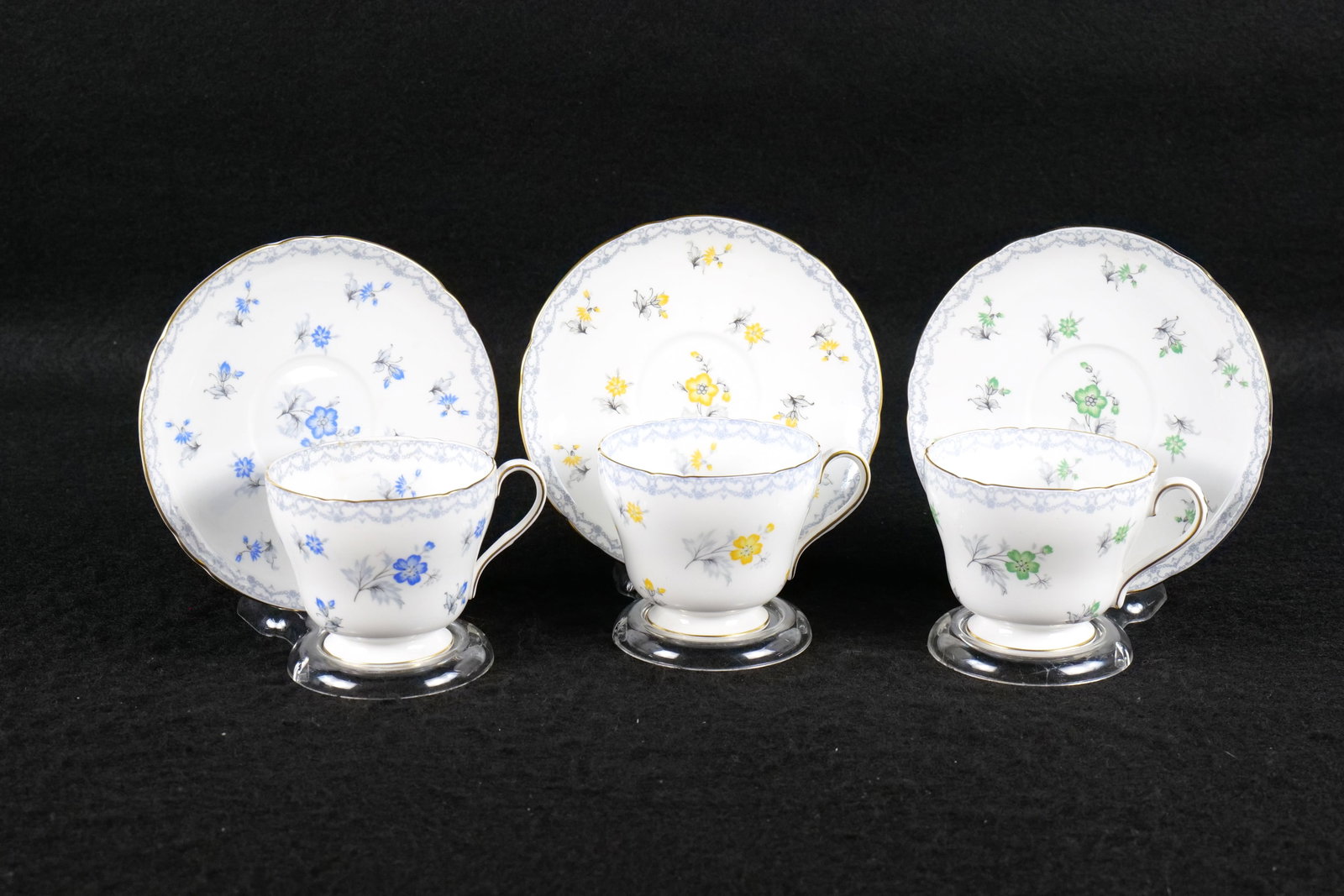 Lot of 3 Shelley "Charm" with Crochet Border Teacups and Saucers: Lot of 3 Shelley "Charm" with Crochet Border Teacups and Saucers. Including Green, Blue, and Yellow Flowers. Two are Pattern #13757 and 1 is Pattern #13749. All Richmond Shaped. This Shelley Collectio