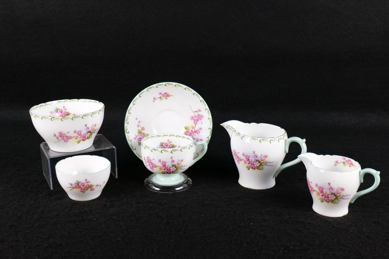Lot of Shelley "Blossom" Bone China Tea ware Pieces: Lot of Shelley "Blossom" Bone China Tea ware Pieces. Including Ely Shaped Cup and Saucer #13513, Small Cream and Sugar, and Large Cream and Sugar. Largest creamer measures 3.75". This Shelley Collecti