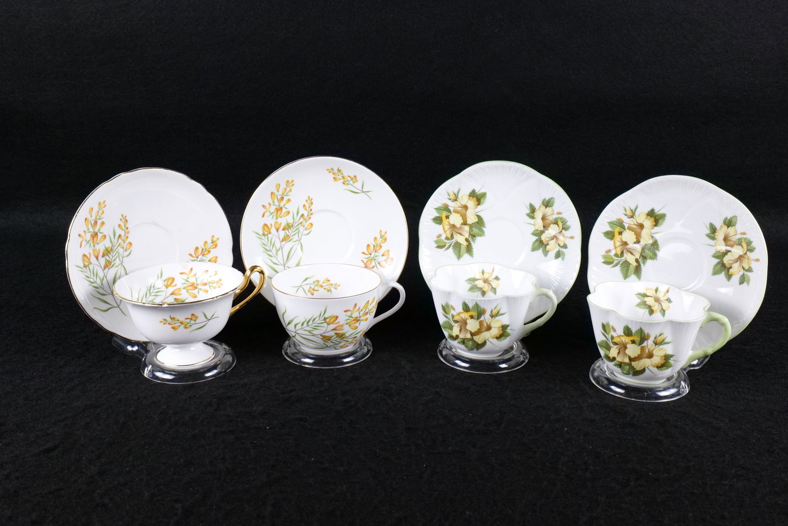 Lot of 4 Shelley Bone China Teacups and Saucers: Lot of 4 Shelley Bone China Teacups and Saucers. Including 2 x "Hibiscus" #13882 - Both Dainty, and 2 Unmarked Pattern Yellow Floral - One in Gainsborough Shape and Other Unknown - Possibly Bute. This