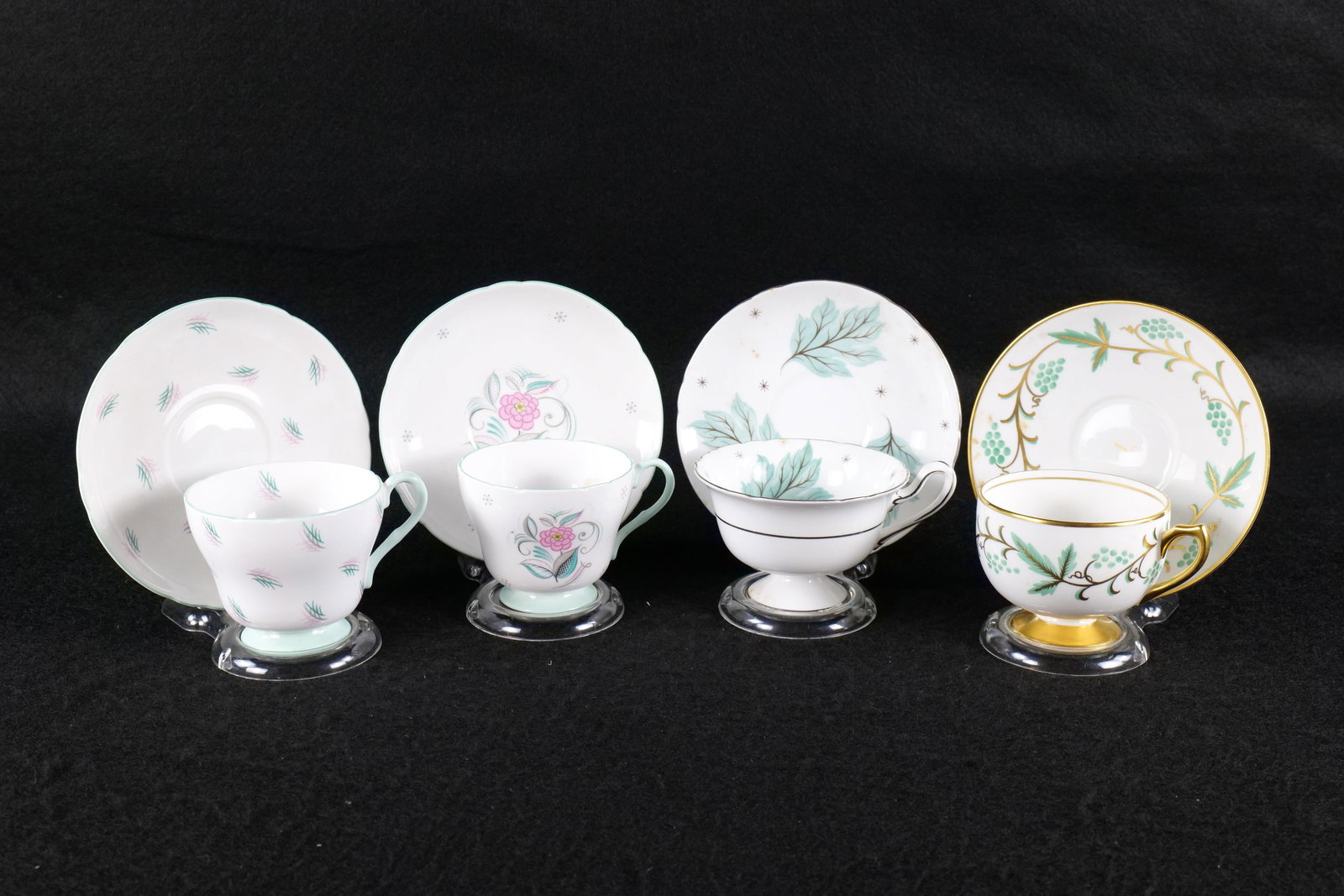 Lot of 4 Shelley Bone China Teacups and Saucers: Lot of 4 Shelley Bone China Teacups and Saucers. Including Richmond Pale Blue and Pink Flowers - Pattern # Undetermined, Richmond "Harmony" #2404, Ely "Grapes and Vine Leaves" #13584, and Gainsborough
