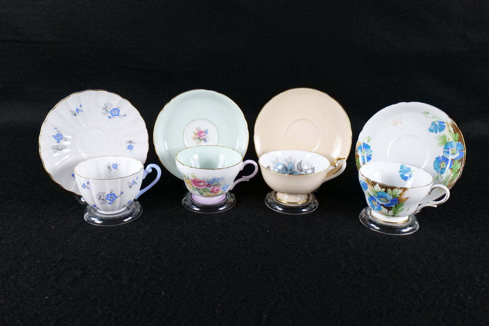 Lot of 4 Shelley Bone China Teacups and Saucers: Lot of 4 Shelley Bone China Teacups and Saucers. Including Henley Shaped Blue Flowers - Pattern # Unidentified- Hairline crack in saucer, Lincoln "Blue Rose" #14245 in Peach, Ludlow "Blue Charm" #2506