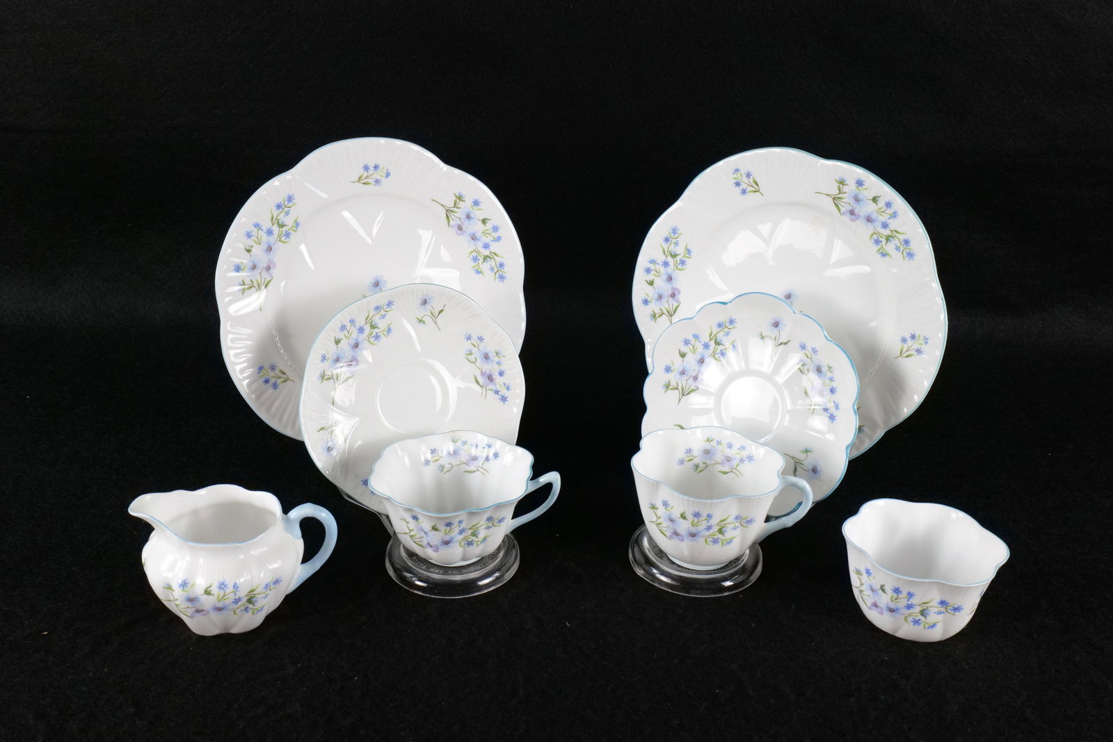 Lot of Shelley "Blue Rock" Bone China Pieces: Lot of Shelley "Blue Rock" Bone China Pieces. Including Creamer, Sugar, and 2 Trios with Cups, Saucers, and 8" Plate. One shaped Dainty and other is Stratford. This Shelley Collection came from the Ju