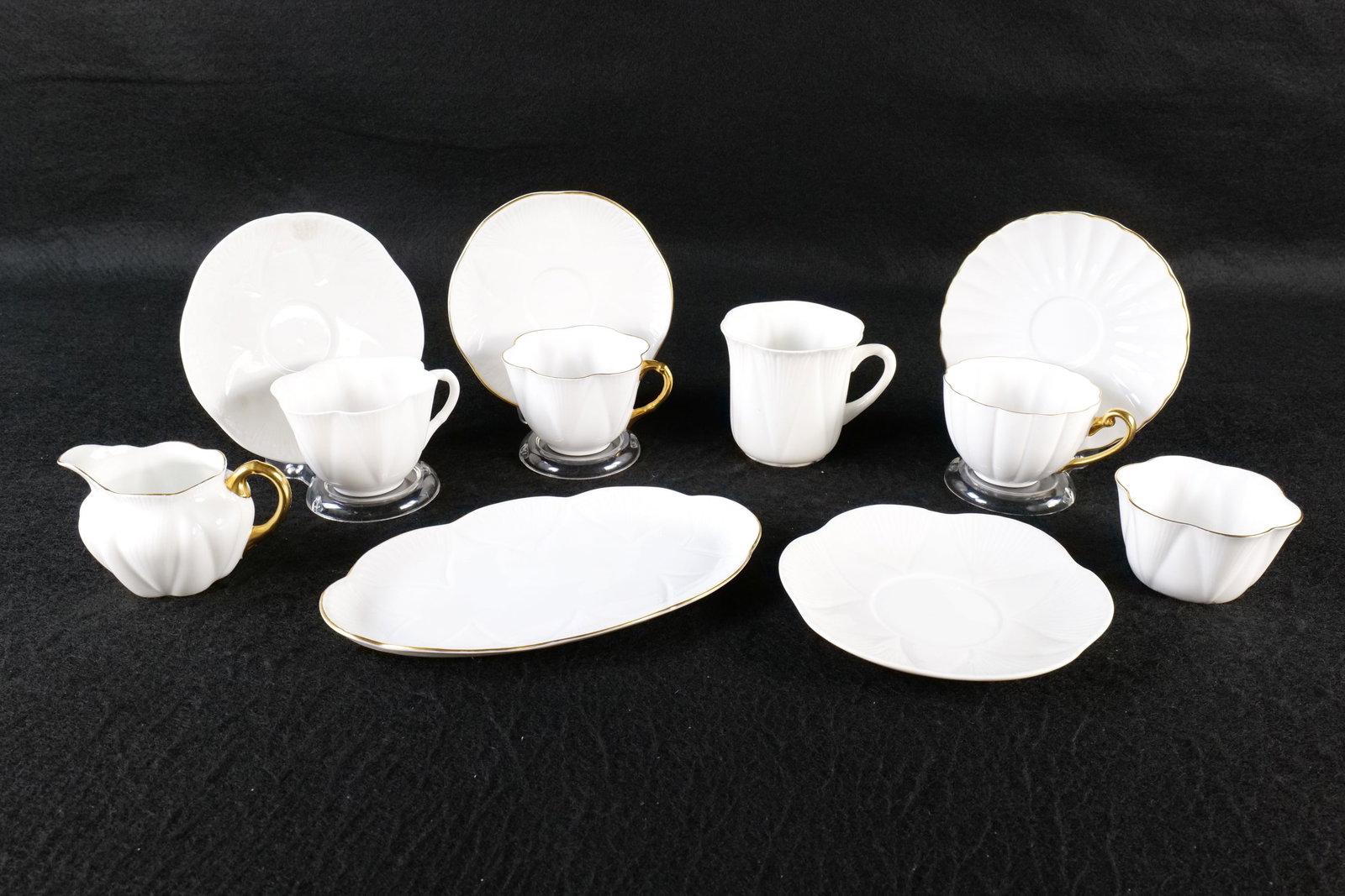 Lot of Shelley Bone China Pieces: Lot of Shelley Bone China Pieces. All White Colored. Including 2 x Dainty Cups and Saucers - One with Gold Rim, Ludlow Shape Cup and Saucer, Tall Dainty Cup and Saucer, Creamer, Sugar and Tray. Tray m