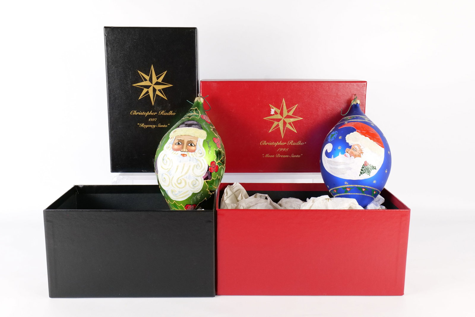 Lot of 2 Christopher Radko Santa Teardrop Ornaments: Lot of 2 Christopher Radko Santa Teardrop Ornaments. Including Moon Dream Santa 1998 and Regency Santa 1997. Measures approx. 10" long. Both come with original boxes. All invoices must be paid within 