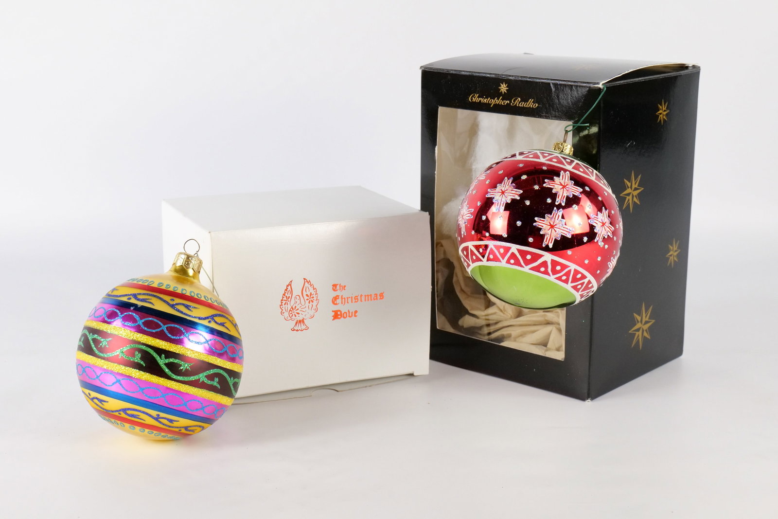 Lot of 2 Christopher Radko Glass Ball Ornaments: Lot of 2 Christopher Radko Glass Ball Ornaments. Including Colorful Banded Swirl - Minor paint discoloration in a couple areas and Snowflake. The colorful one does have some paint loss in a couple are