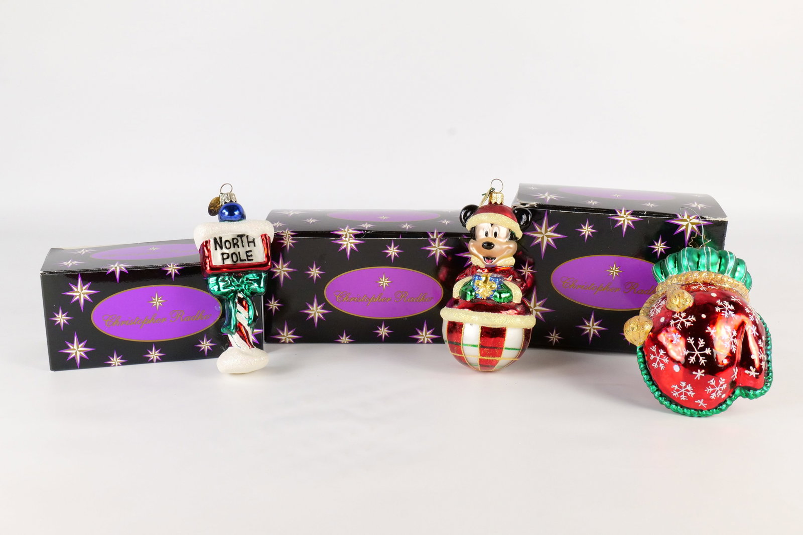 Lot of 3 Christopher Radko Christmas Ornaments: Lot of 3 Christopher Radko Christmas Ornaments. Including Rollin Mickey, Kniten Mitten, and Signs of Santa. Largest measures approx. 5". All come with Radko boxes - May not be original to the ornament