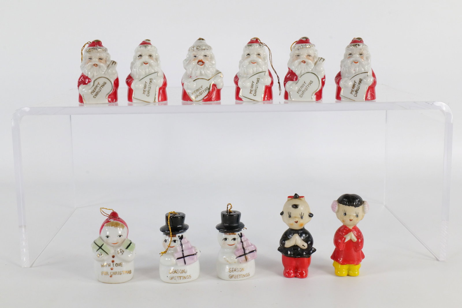 Lot of Ceramic Christmas Bells: Lot of Ceramic Christmas Bells. Also includes 2 Asian Inspired Figures. Including 6 Santa Bells, 2 Snowmen Bells, and Snow Lady Bell. Some paint wear and snow lady has a crack and some others have fle