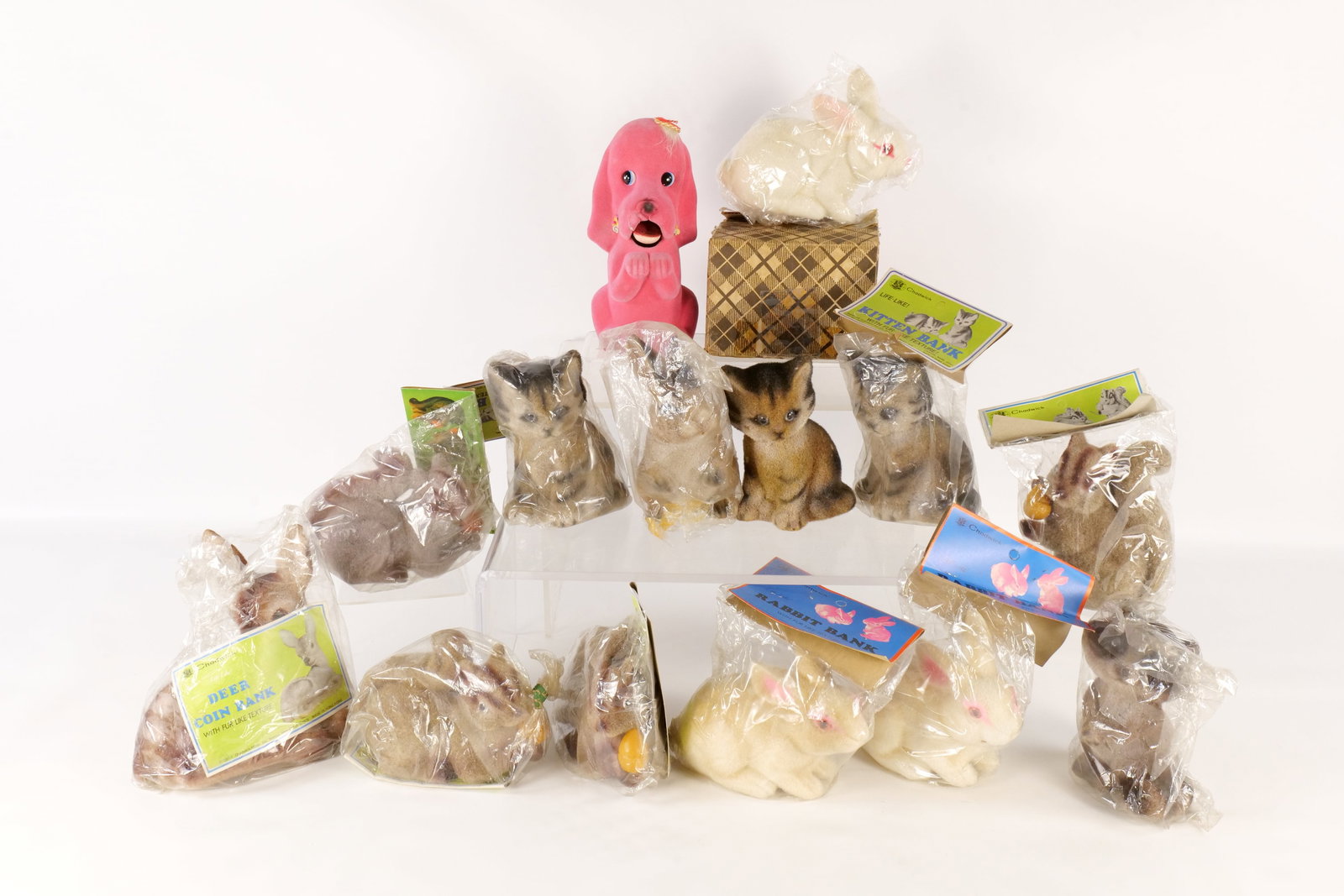 Lot of Fuzzy Animal Banks: Lot of Fuzzy Animal Banks. Many in Plastic. Includes Bunnies, Cat, Squirrel, and More. Some cracking on the pink dog bank. All invoices must be paid within 24 hours of the sale. We offer multiple ship