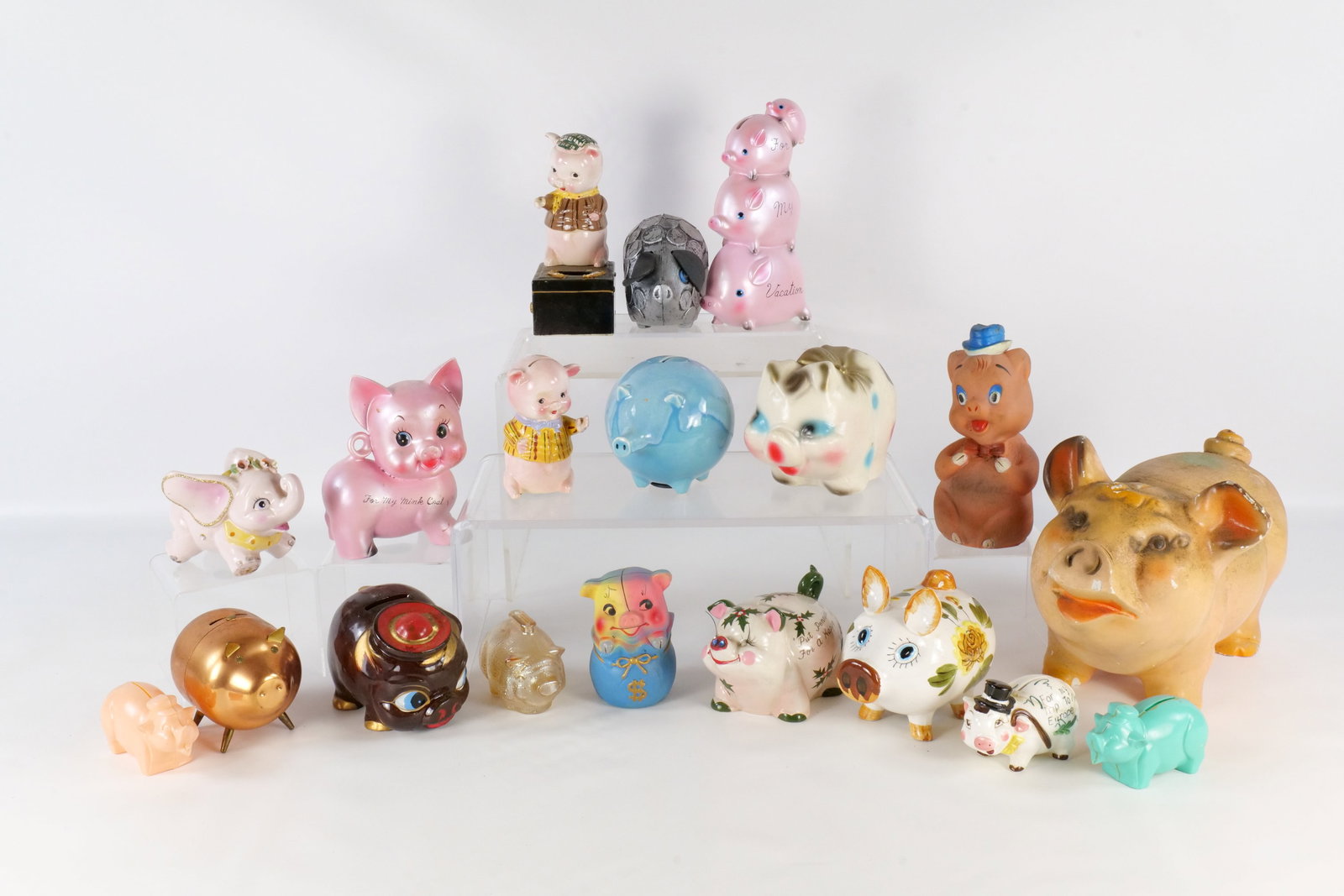 Lot of Piggy Banks: Lot of Piggy Banks - Metal, Plastic, Resin, Glass and Ceramic. Some missing plugs. Some have paint chips. Largest measures 13" long. All invoices must be paid within 24 hours of the sale. We offer mul