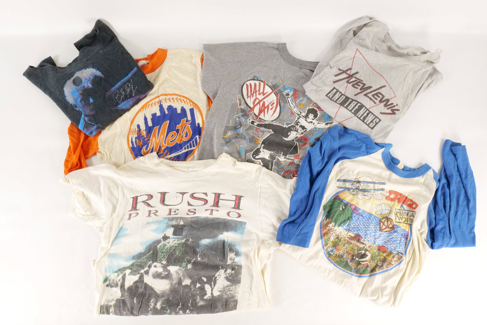 Lot of Vintage T-Shirts: Lot of Vintage T-Shirts. Including Billy Idol, Men at Work, Rush, Mets, Hall and Oates, and More. Multiple shirts have some tears and staining. Appears to be Youth Large to an Adult Medium. All invoic