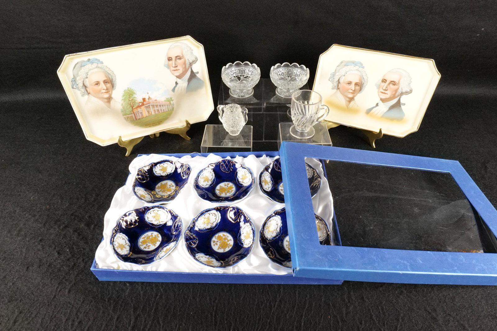 Lot of Assorted Collectibles: Lot of Assorted Collectibles. Including George and Martha Washington Porcelain Vanity Trays, Set of 6 Hand Decorated Cobalt Blue Dishes in Box, and More. Plate and Cup have a crack. All invoices must 
