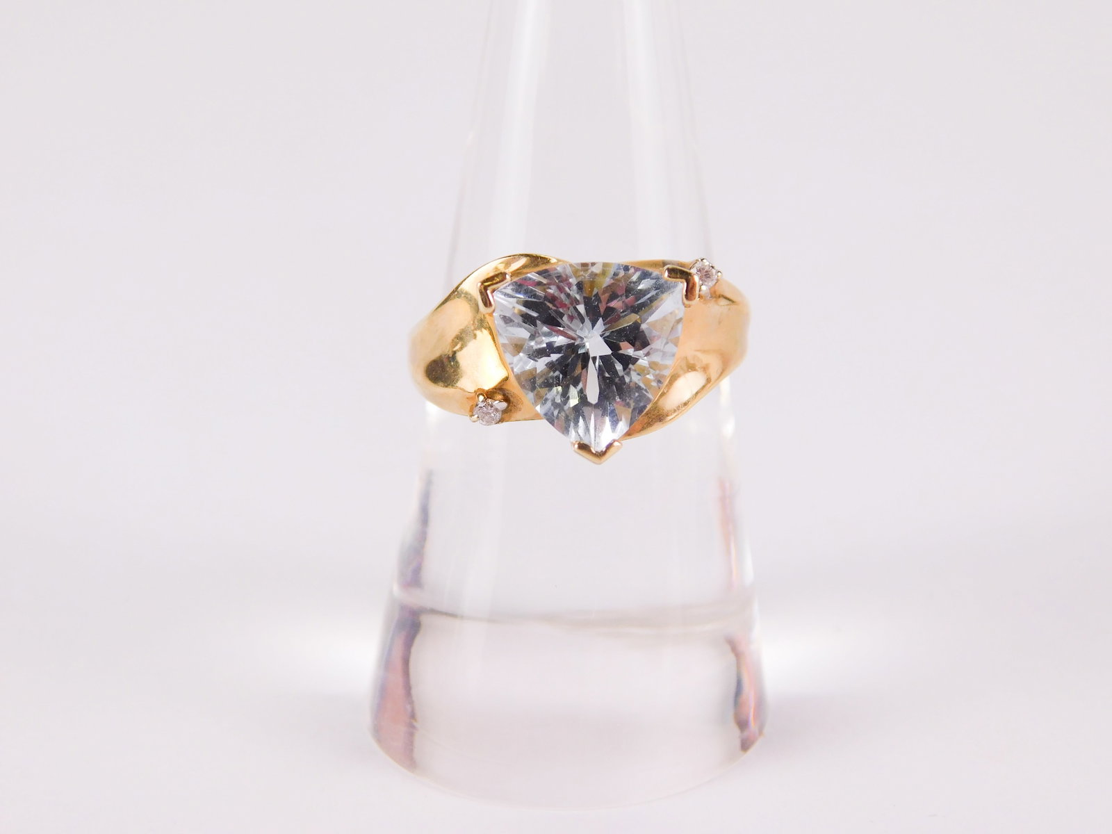 14k Yellow Gold, Aquamarine and Diamond Ring: 14k Yellow Gold, Aquamarine and Diamond Ring. The band is a gradient size with a faceted trillion cut 10.6 mm aquamarine and 2 round cut diamonds on either side. Marked. Size 7 1/2. All invoices must 
