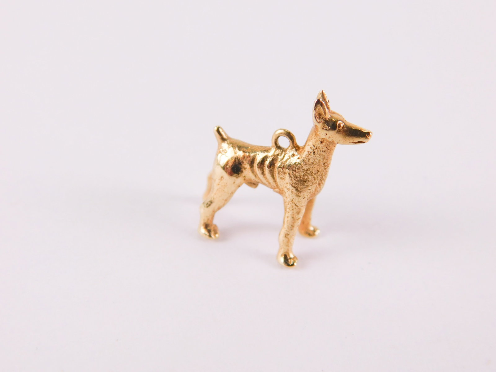 14k Yellow Gold Dog Charm: 14k Yellow Gold Dog Charm. Appears to be a German Sheppard. Marked. Measures 1/2". Weighs approx. 3.8 grams. All invoices must be paid within 24 hours of the sale. We offer multiple shipping options, 