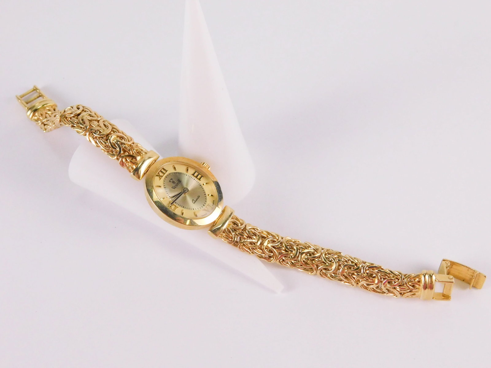 14k Vicence Ladies Watch: 14k Vicence Ladies Watch. Has a byzantine link watch band. Marked on the back and on the band 14k Italy. Measures 7 1/4". Weighs approx. 21.2 grams with movement. All invoices must be paid within 24 h