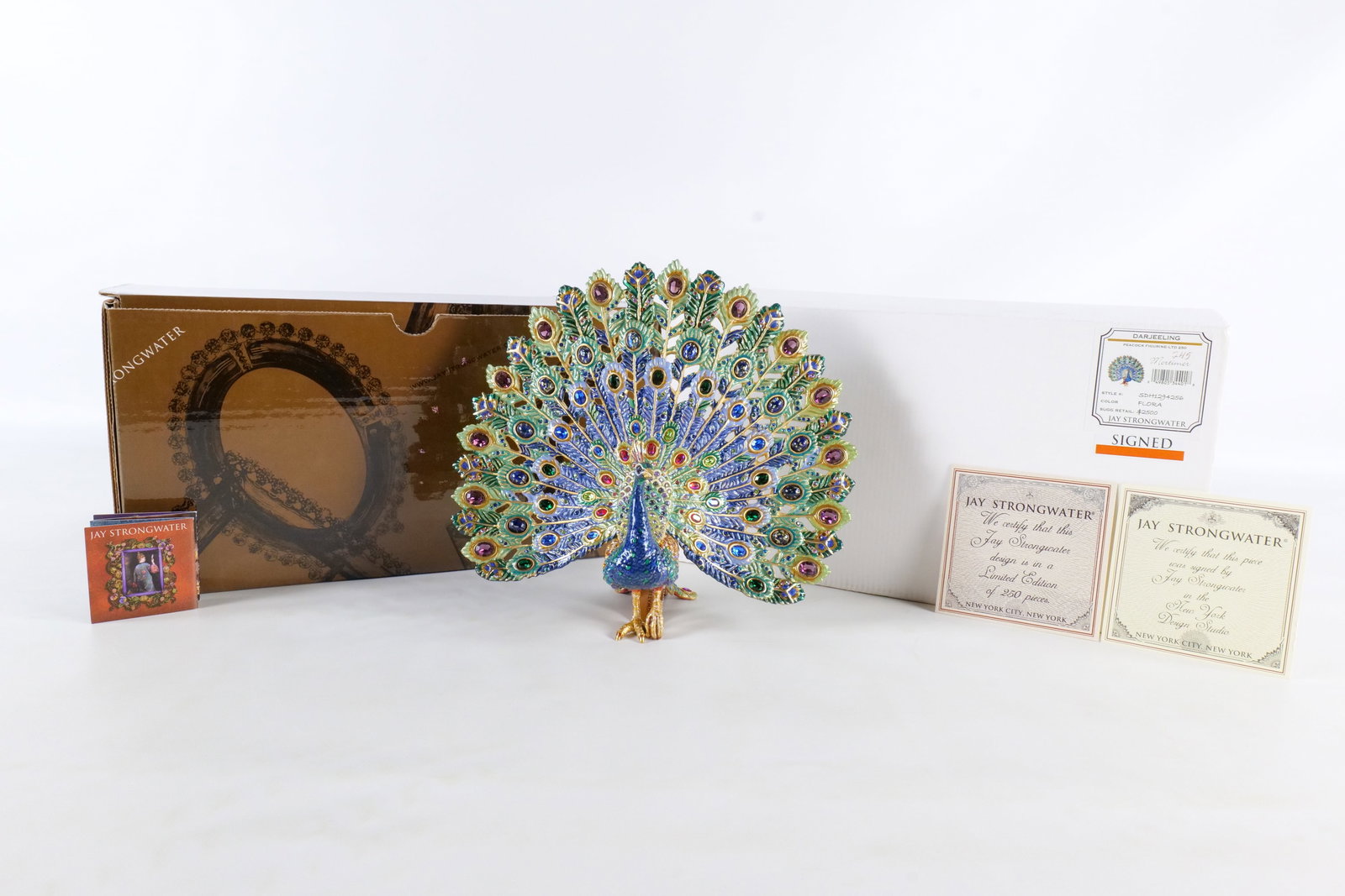 Jay Strongwater Mortimer Peacock Figurine - Signed: Jay Strongwater "Mortimer" peacock figurine. From the Darjeeling collection. Color Flora. Style SDH1294256. The piece has blue, green, pink and cream enameled tones throughout with multiple cut and ca