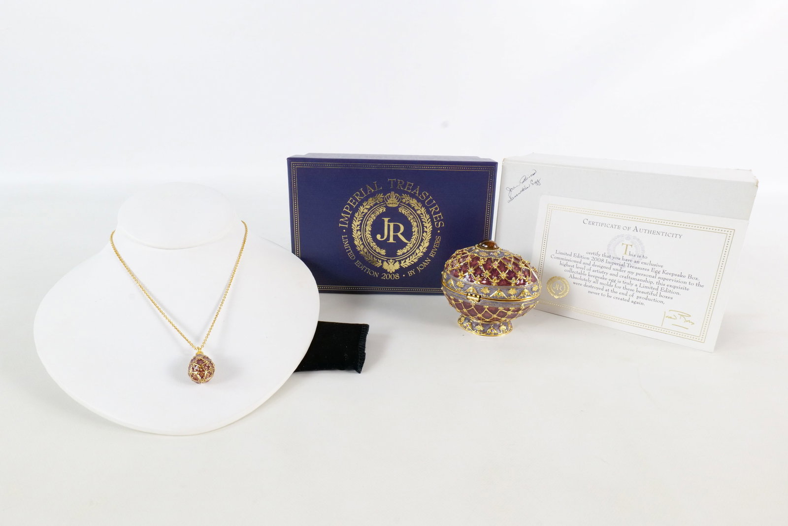 Joan Rivers Imperial Treasures Egg Keepsake Box with Necklace: 2008 Joan Rivers Imperial Treasures Egg Keepsake Box with matching necklace. Burgandy and stone gray enamel with multi colored rhinestones through the diamond pattern and egg. Has an oval cabochon tig