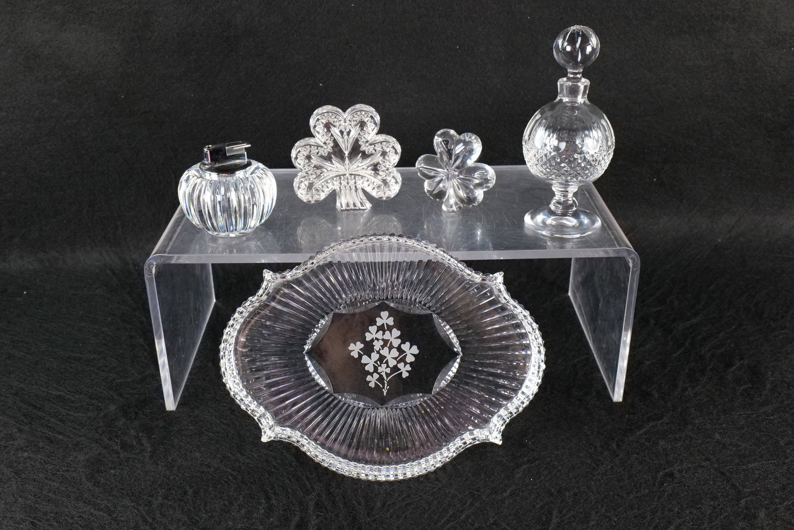 Group of Waterford Crystal: Group of Waterford crystal including a skirted dresser tray with 3 leaf clover design, a lighter, scent bottle and 2 clover paperweights. All various patterns. Larges measures approx. 7" tall. All inv