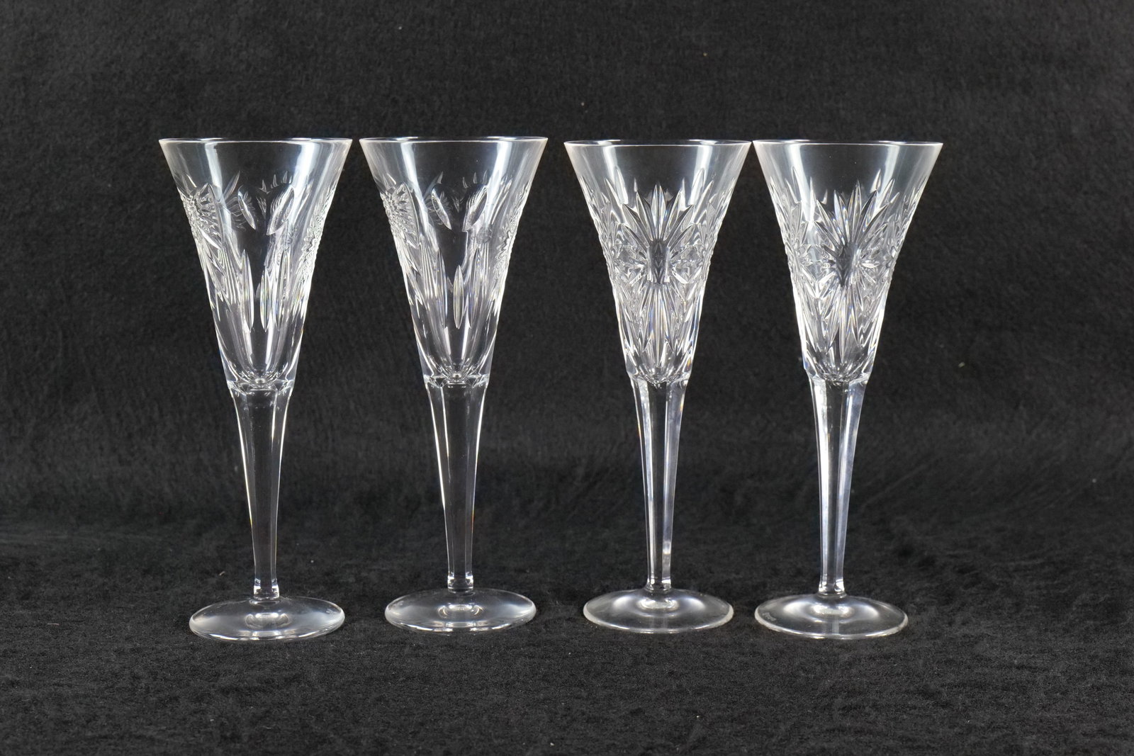 4 Waterford Champagne Flutes: 4 Waterford millennium series champagne flutes. 3 different styles including love. Measures approx. 9 1/2" tall x 3" in diameter. All invoices must be paid within 24 hours of the sale. We offer multip