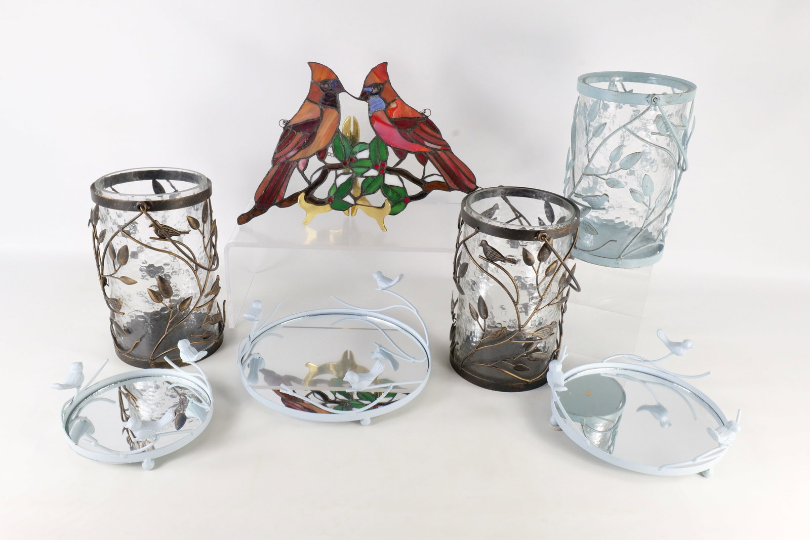 Group of Bird D?cor: Group of bird decor including a handling stained glass cardinal panel, a set of 4 bird lanterns and a set of 3 bird iron plateaus with mirrors. Largest measures 10" tall. All invoices must be paid wit
