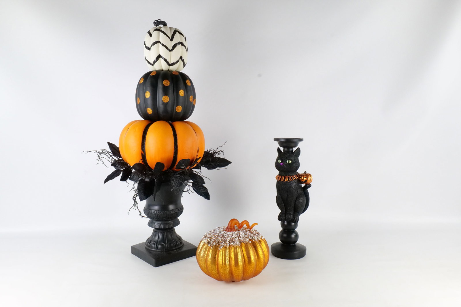 Group of Holiday D?cor: Group of Halloween decor including a mercury glass style light up pumpkin with rhinestones, resin black cat candle holder and a trio of pumpkins topiary in a black planter. Largest measures 32" tall. 