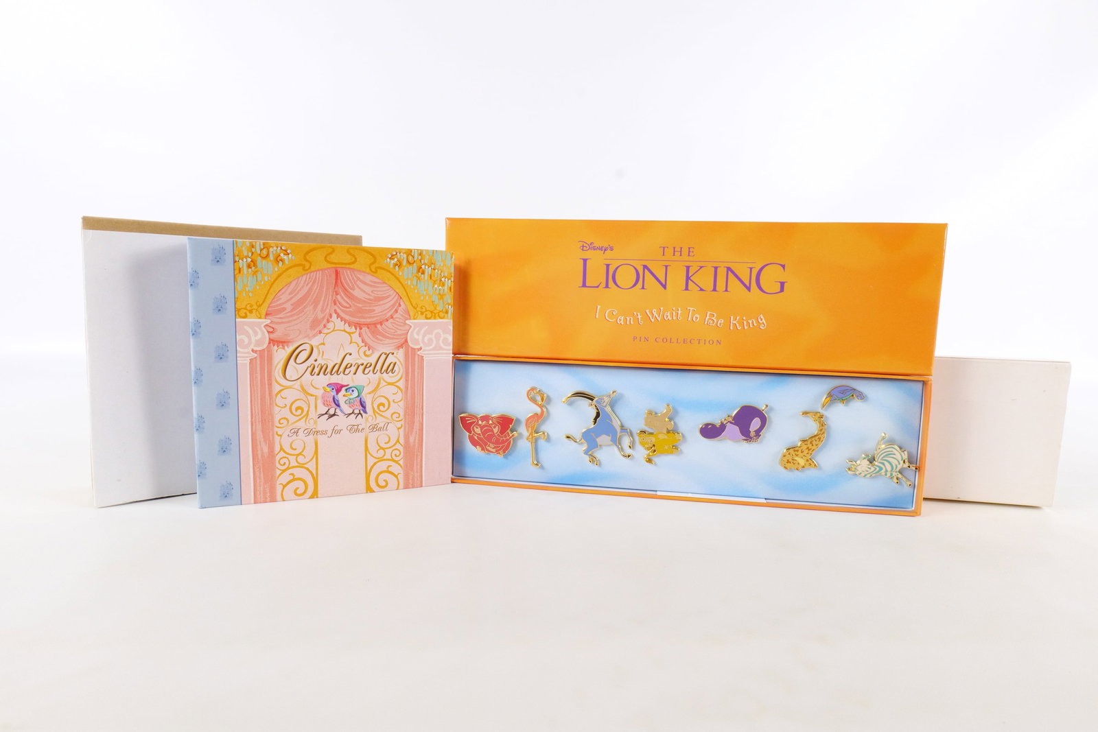 Lot of Disney Pins: Lot of Disney Pins. Including Cinderella - A Dress for the Ball - Disney Storybook Collection Pin and The Lion King "I Can't Wait to be King" Pin Collection. Both come with original boxes. All invoice