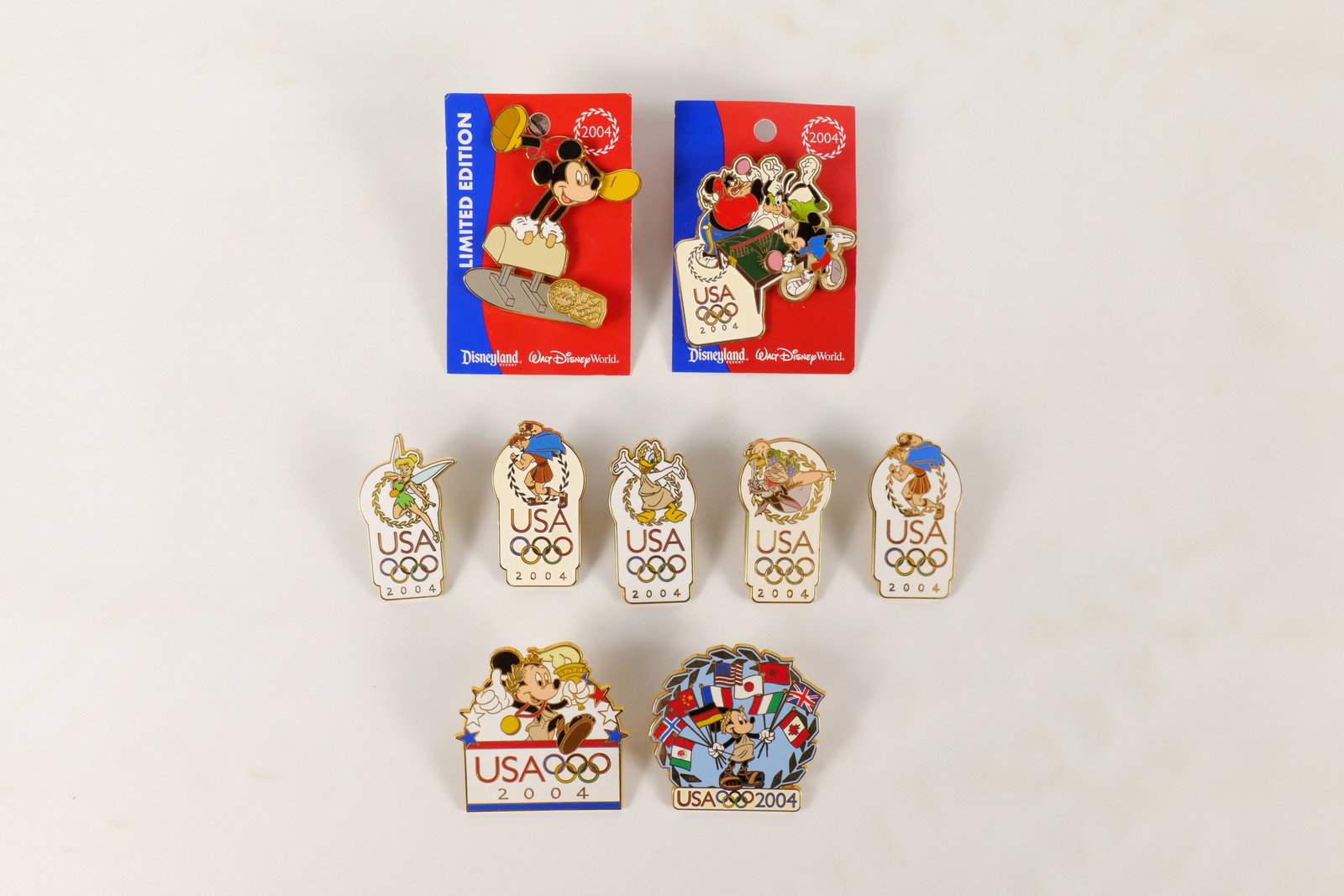 Lot of 9 Disney 2004 Olympics Pins: Lot of 9 Disney 2004 Olympics Pins. Including Hercules, Tinker Bell, Mickey Mouse, Donald, and More. Including 1 Limited Edition and 2 on Card Backs. All invoices must be paid within 24 hours of the s