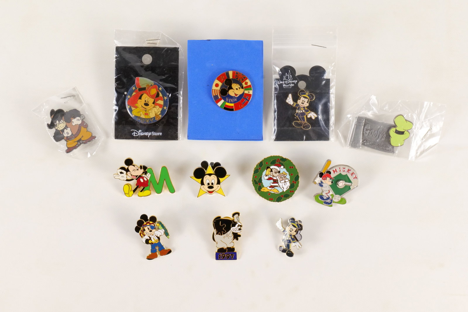 Lot of 12 Disney Character Pins: Lot of 12 Disney Character Pins. Including Mickey Baseball, Police Mickey, Goofy Movie, Epcot Mickey, Peg Leg Pete, Pirate Mickey and More. All invoices must be paid within 24 hours of the sale. We of