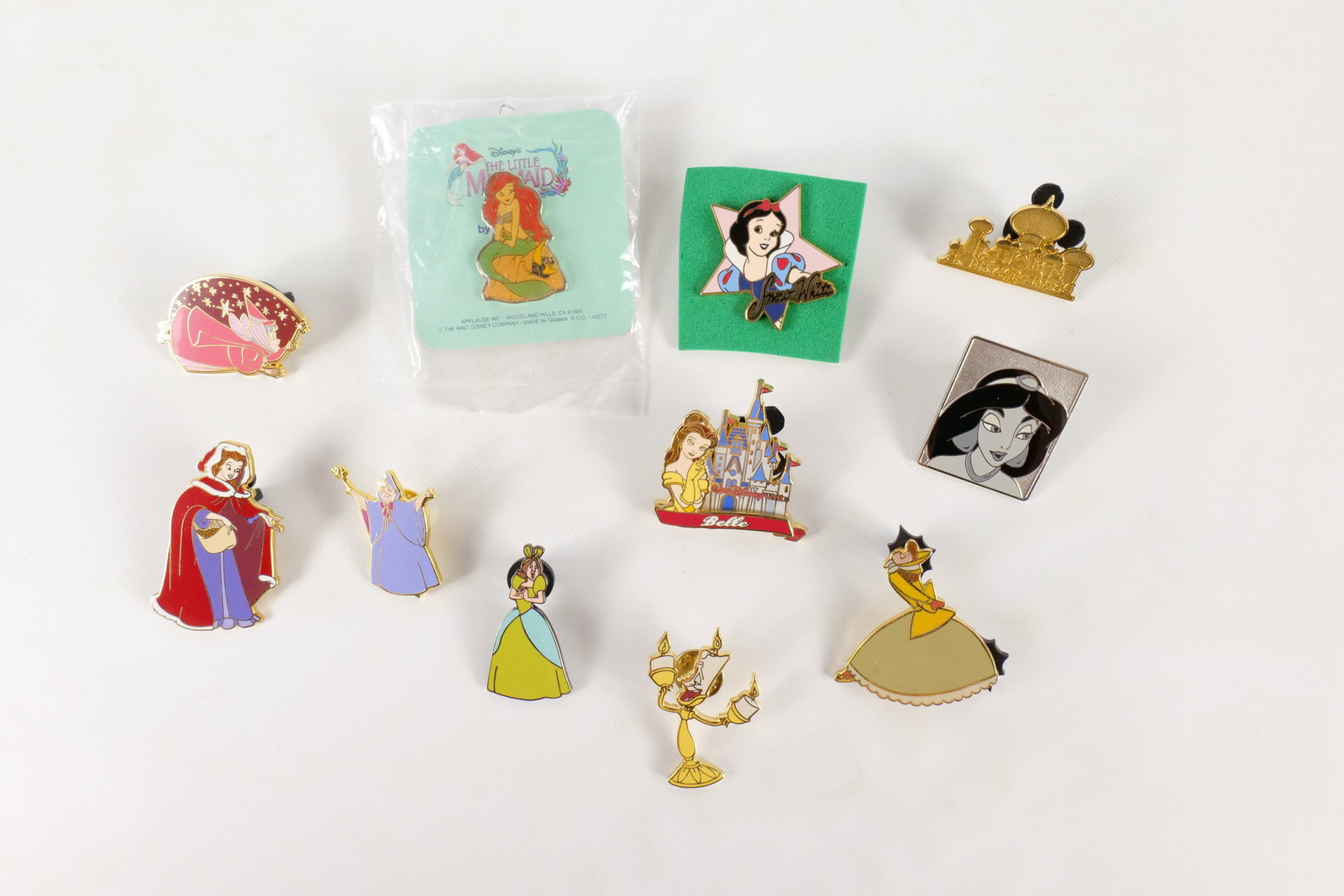 Lot of 11 Disney Pins: Lot of 11 Disney Pins. Including Snow White with Star, The Little Mermaid, Fairy Godmother, Belle, Lumiere, Jasmine, and More. One comes with card back. All invoices must be paid within 24 hours of th