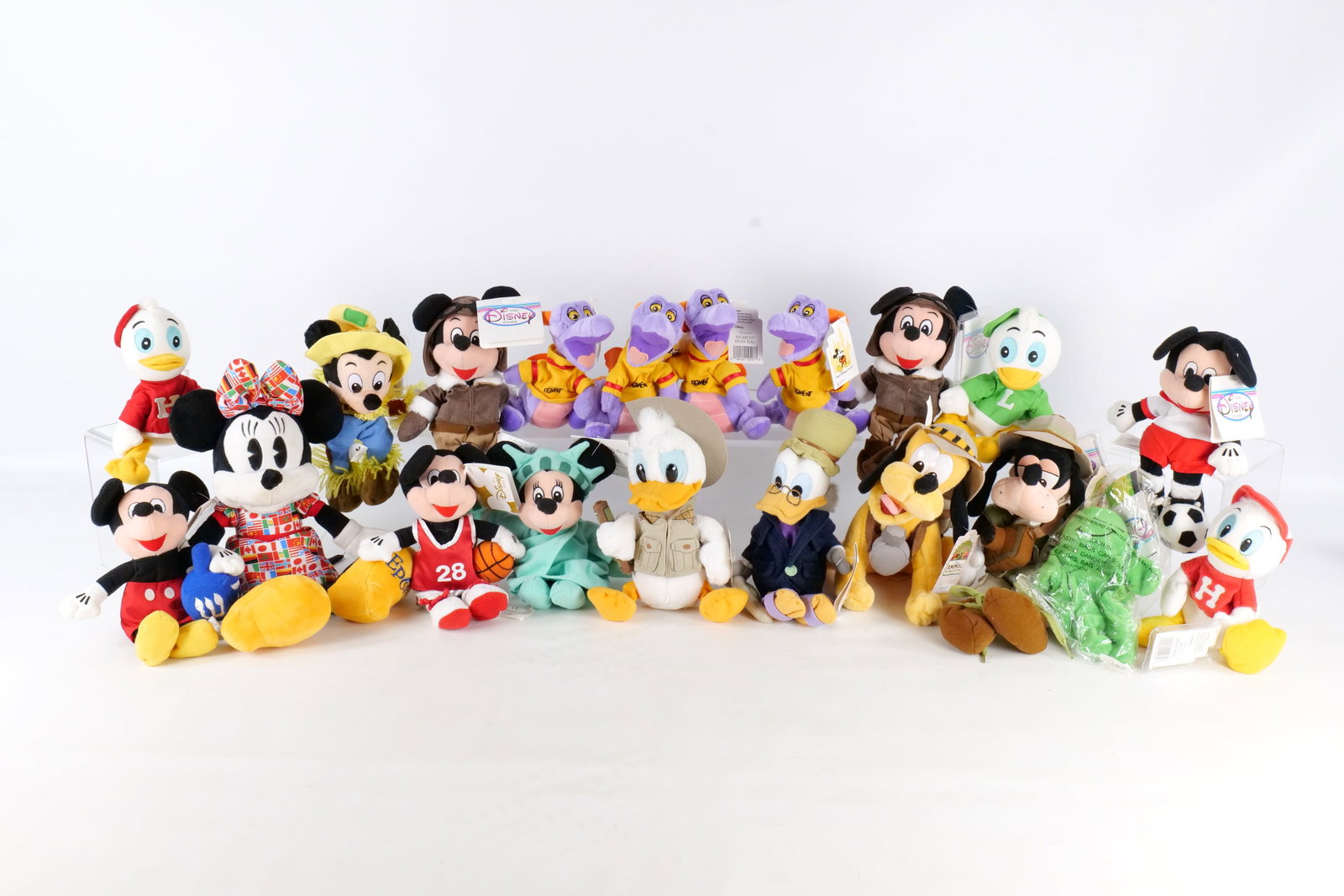 Lot of Disney Bean Bag Plush: Lot of Disney Bean Bag Plush. Including Goofy in Safari Outfit, Donald in Safari Outfit, Figment, Statue of Liberty Minnie, Mickey Mouse with Basketball, Mickey Mouse with Dreidel, and More. Most come