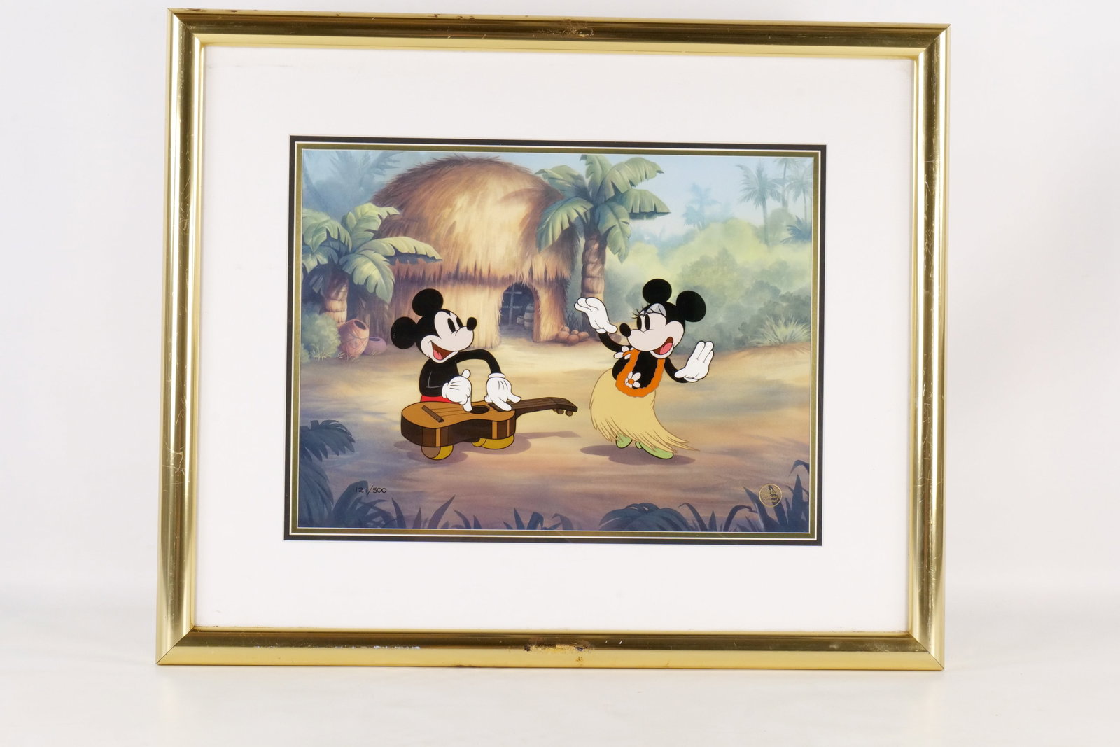 Disney "Hawaiian Holiday" Hand Painted Animation Cel: Disney "Hawaiian Holiday" Limited Edition Hand Painted Animation Cel. Depicting Mickey Mouse sitting on a beach strumming a guitar while Minnie Mouse dances in a Hula skirt. Limited Edition #121 out o