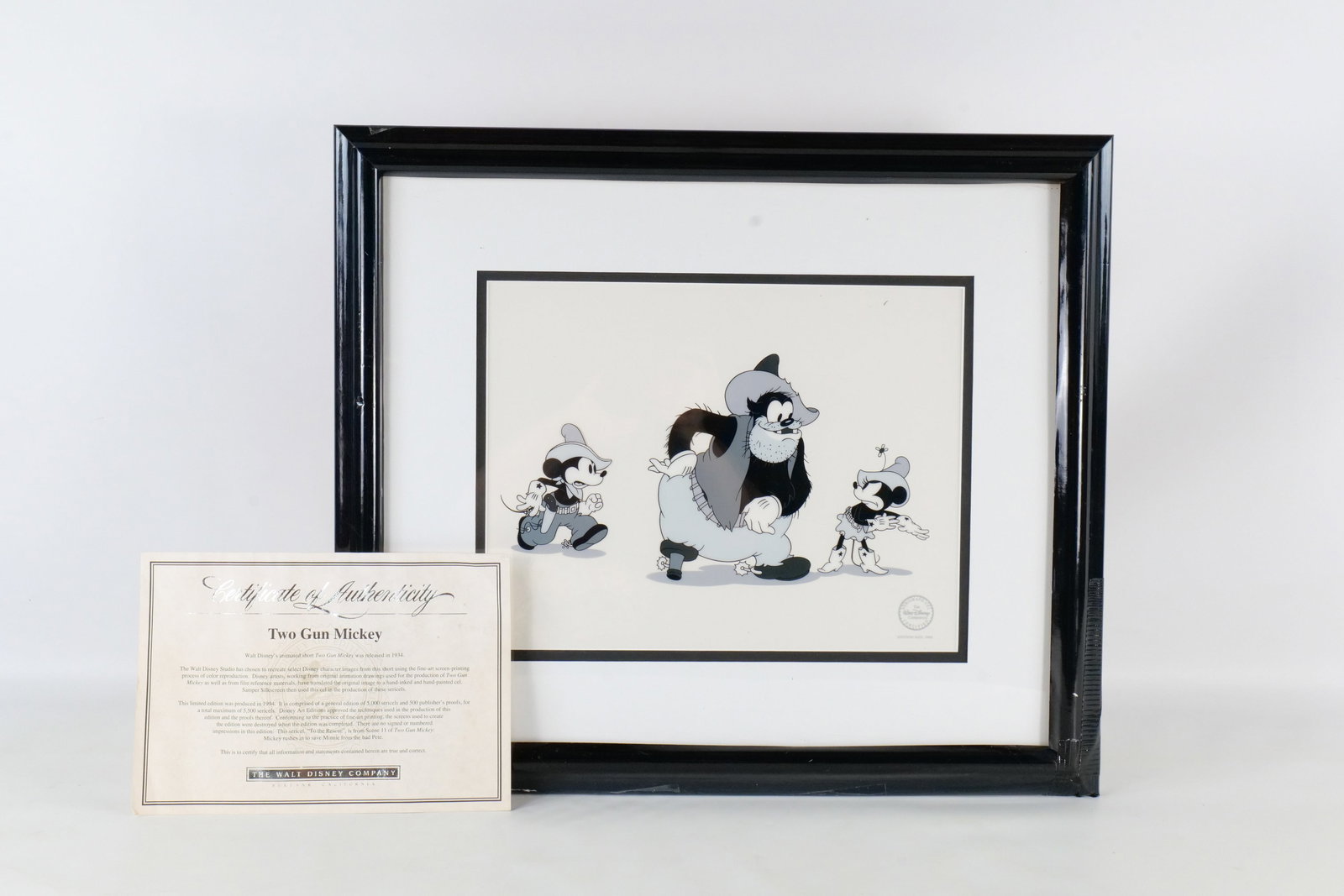 Walt Disney "Two Gun Mickey" Sericel: Walt Disney "Two Gun Mickey" Sericel. Featuring Mickey, Minnie, and Pete. Limited Edition out of 5000 pieces. Comes with COA. Framed and matted frame has damage and tape to the black border. Measures 