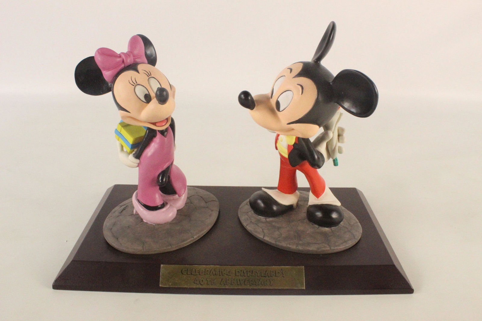 Disneyland 40th Anniversary Mickey and Minnie Mouse Resin Figurine: Disneyland 40th Anniversary Mickey and Minnie Mouse Resin Figurine. Limited to 1500 pieces. Signed on back by artist Marc Delle. Comes on wooden base. Measures 8 1/2 inches tall by 12 3/4 inches wide.