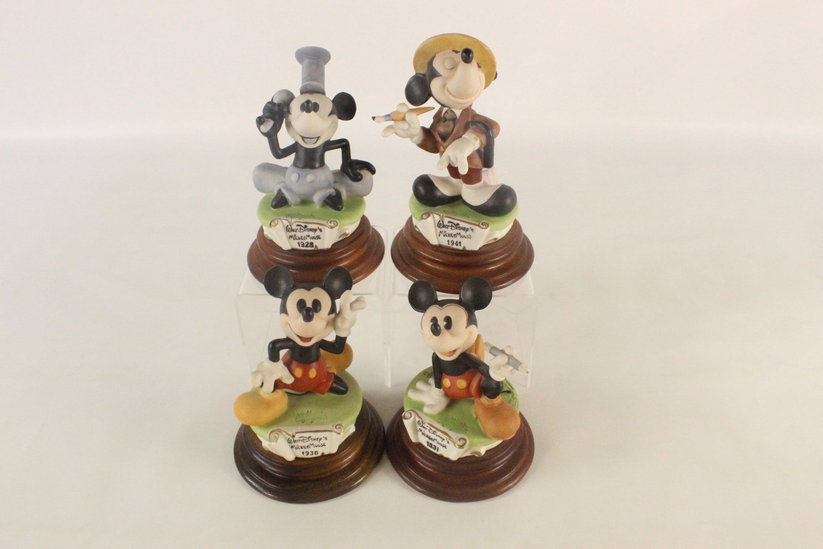 Lot of 4 Laurenz Capodimonte Mickey Mouse Through the Years Figurines: Lot of 4 Laurenz Capodimonte Mickey Mouse Through the Years Figurines. Including 1928 Steamboat Willie, 1931 Mickey Mouse with pencil, 1936 Mickey Waving, and 1941 The Little Whirlwind. Made in Italy.