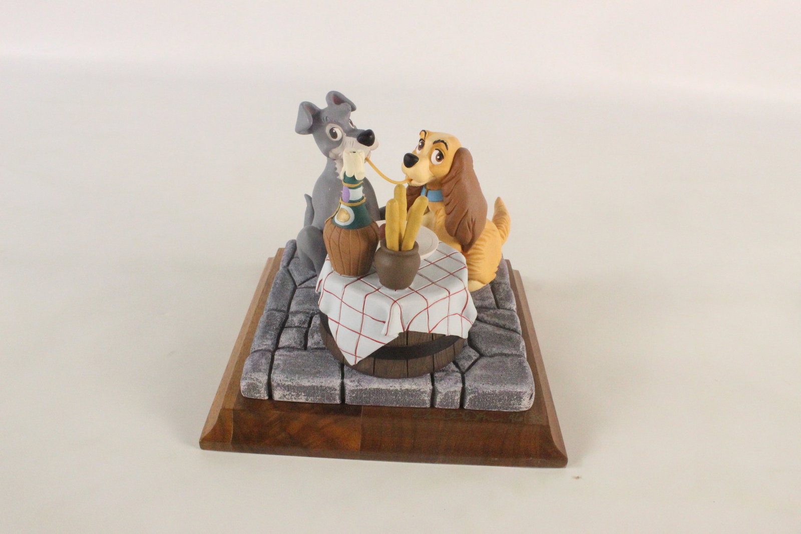 Lady and the Tramp Limited Edition Disney Figurine: Lady and the Tramp Limited Edition Disney Figurine. Produced by artist David Karcov. Resin figure mounted on wood base. Limited Edition #46 of 75. Depicting Lady and the Tramp sharing the spaghetti di