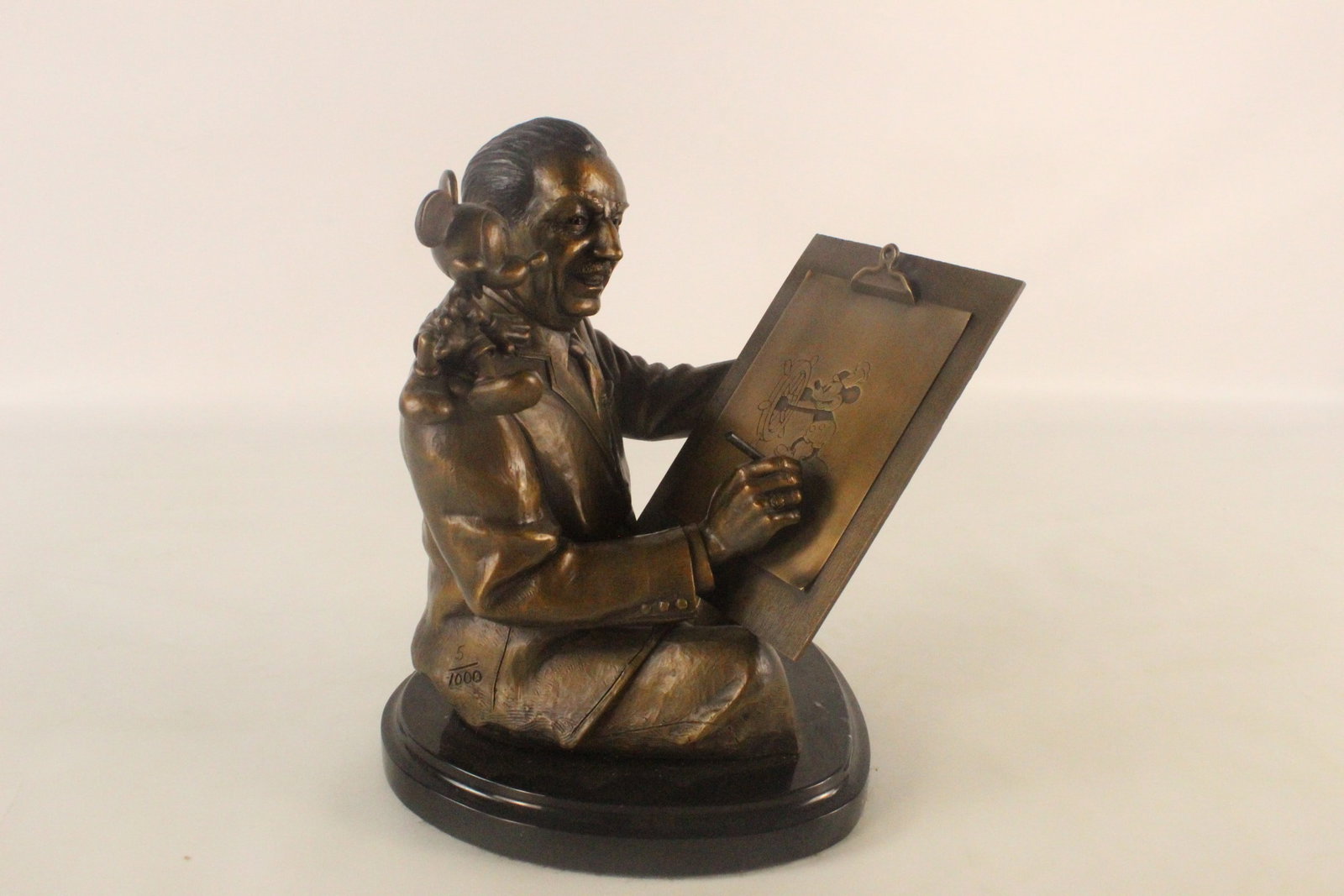 Bronze "Walt and Mickey Sketching" Statue: Bronze "Walt and Mickey Sketching" Statue. Created by Marc Delle. Comes on black Marble base. Depicting Walt Disney with Mickey on his shoulder drawing an image of Steamboat Willie. Limited edition #5