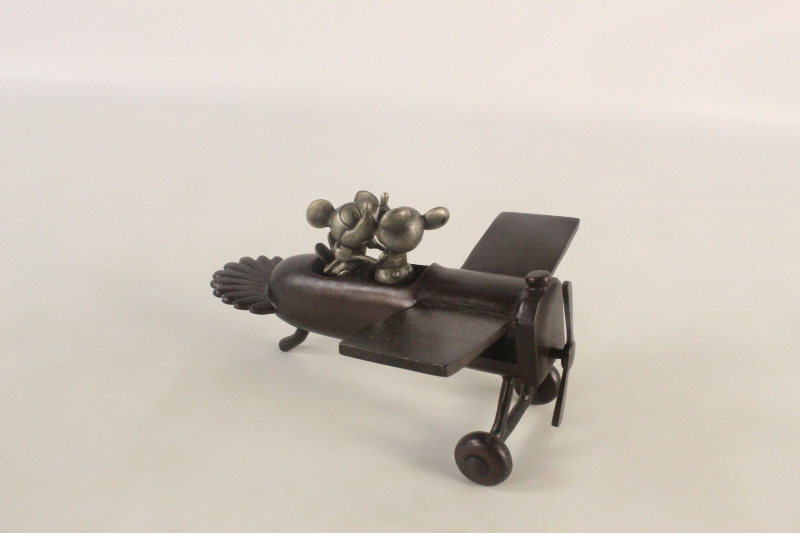 Bronze "Plane Crazy" Mickey and Minnie's First Kiss Figurine: Bronze "Plane Crazy" Mickey and Minnie's First Kiss Figurine. Limited Edition 1500 Pieces. Originally came with a base that is missing. Figurine only - please see photos. Stands up well even though mi