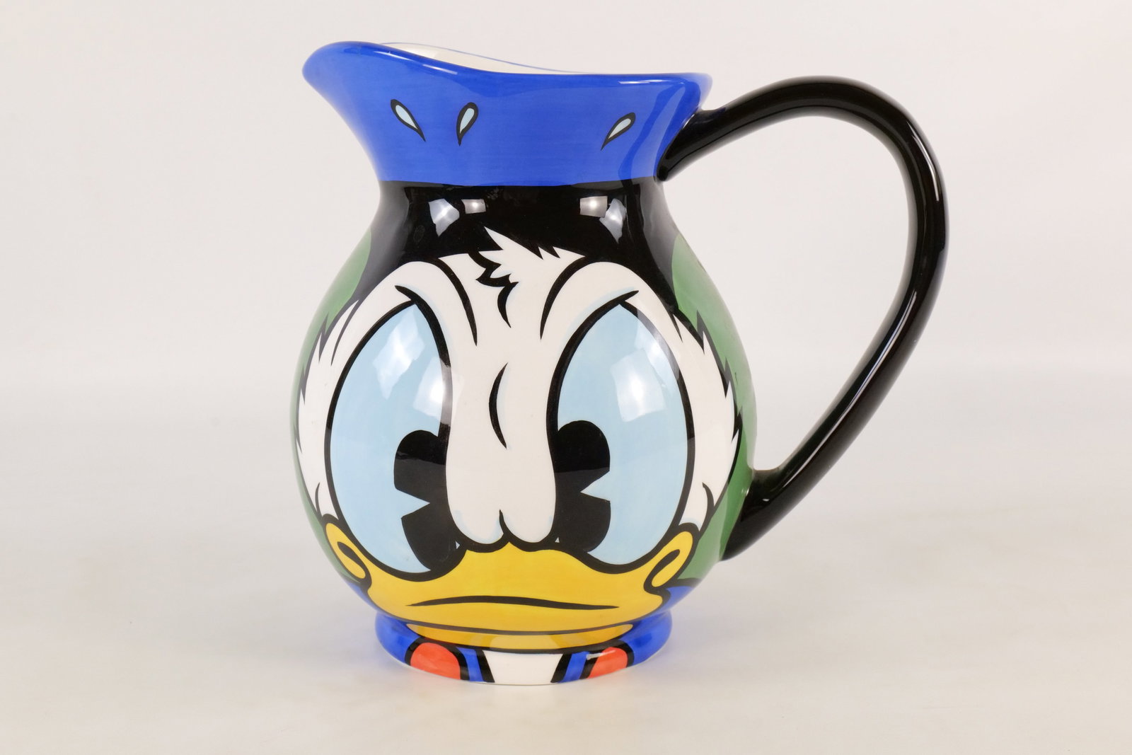 The Art of Disney Ceramic Donald Duck Hand Painted Pitcher: The Art of Disney Ceramic Donald Duck Pitcher. Measures 9 1/2 inches tall by 11 inches wide. Small chip on rim. All invoices must be paid within 24 hours of the sale. We offer multiple shipping option