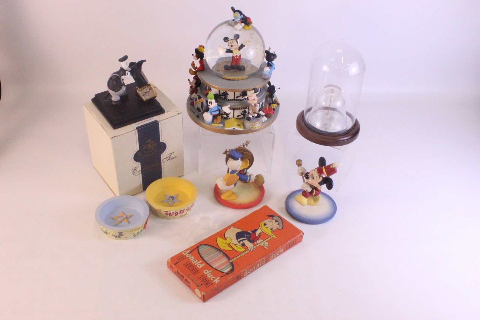 Lot of Disney Collectibles: Lot of Disney Collectibles. Including a Steamboat Willie Fossil Watch with Peg Leg Pete Base - Base has wear - Comes with box, Vintage Donald Duck Sunshine Straws, Frosted Glass Mickey Bell - Mickey i