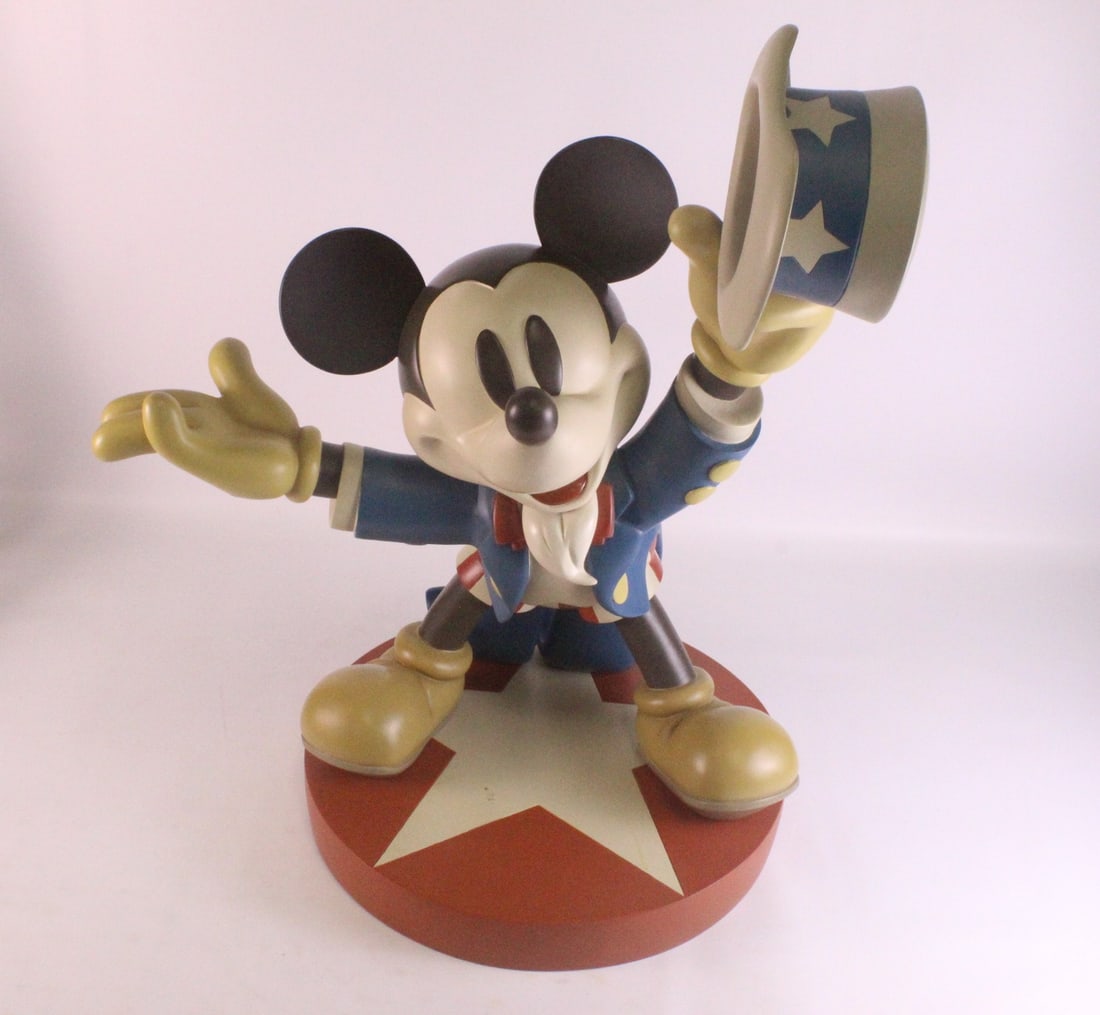 The Disney Store Mickey Mouse as Uncle Sam Resin Big Fig: The Disney Store Mickey Mouse as Uncle Sam Resin Big Fig. The base does have some scratching and scuffing throughout. Measures 25 inches tall with the base. Mickey's arm span measures approximately 20