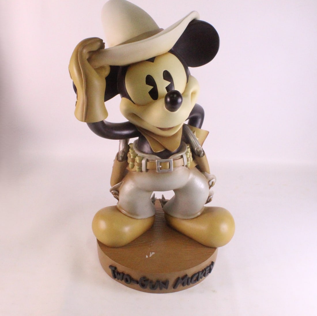 Disney Two-Gun Mickey Big Fig Statue: Disney Two-Gun Mickey Big Fig Statue. Made of resin. Comes with base. Base has a significant scratch mark. Mickey measures 22 inches tall on the base by 13 inches wide. The base measures 11 inches in 