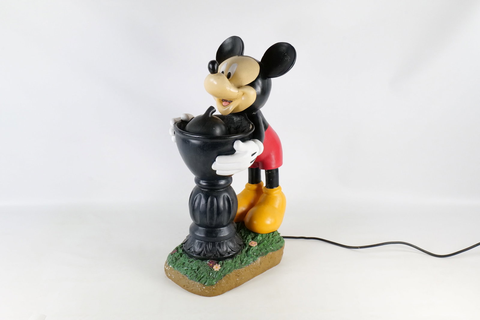 Mickey Mouse Drinking Water Fountain: Mickey Mouse Drinking Water Fountain. For indoor or outdoor use. Does have some loss to paint in multiple areas. Mickey's head has been repaired. AS-IS. Comes with pump and cord. Untested. Measures 25