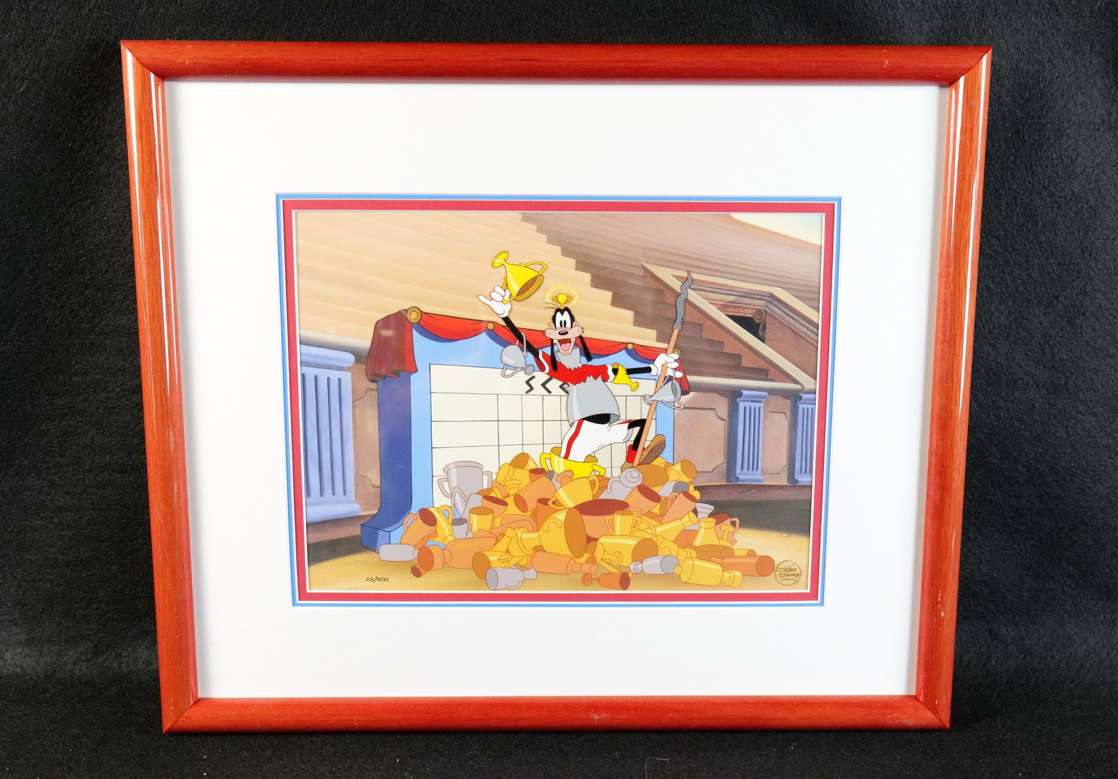 Disney "The Olympic Champ" Hand Painted Character Cel: Disney "The Olympic Champ" Hand Painted Character Cel. Depicting Goofy in a pile of trophies from the 1942 animated short The Olympic Champ. Limited Edition #28 of 500. Comes with the Disney Gold seal