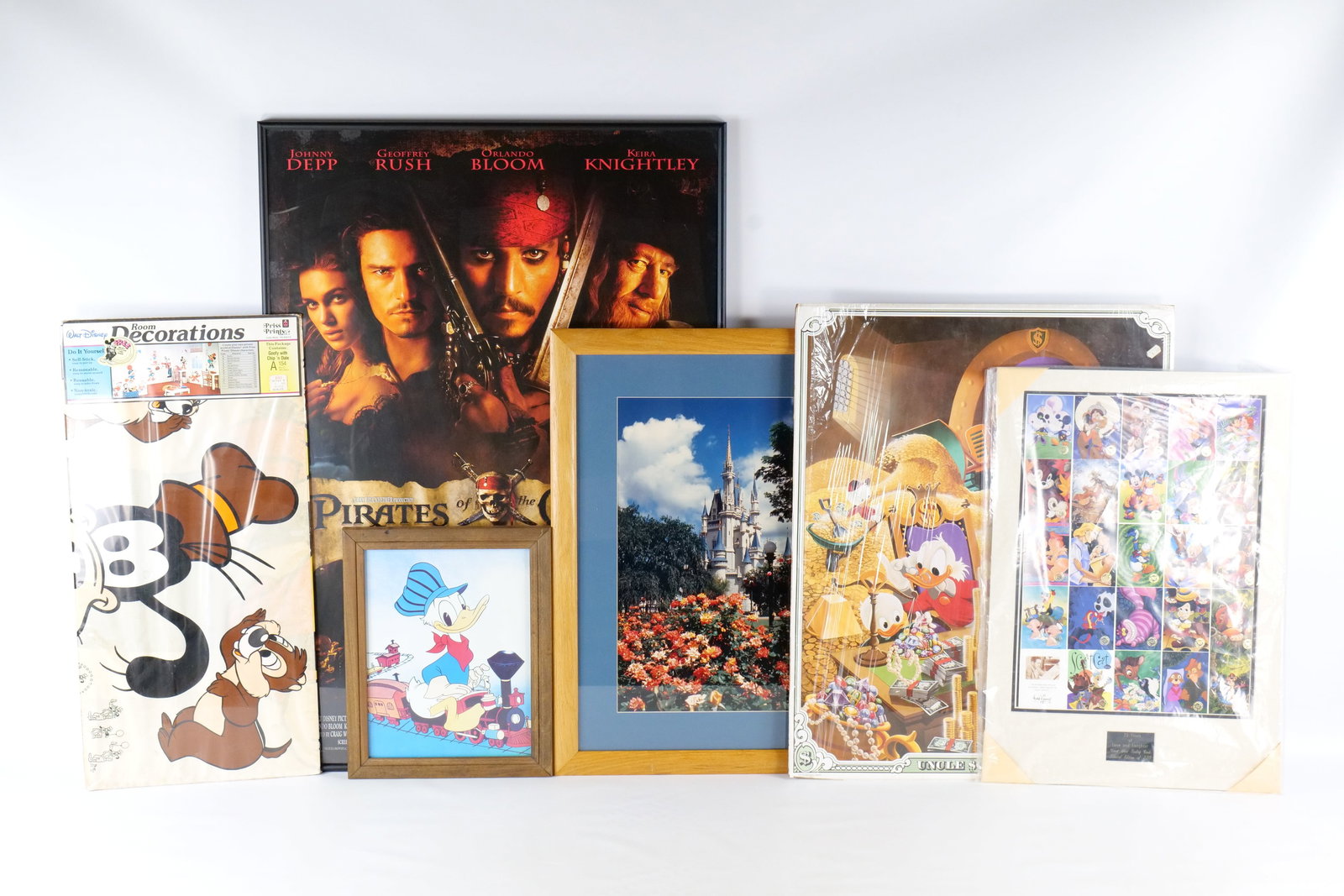 Lot of Disney Posters, Trading Cards, Cutouts, and Photograph: Lot of Disney Posters, Trading Cards, Cutouts, and Photograph. Including frames Pirates of the Caribbean The Curse of the Black Pearl Poster, Vintage Cinderella Castle Photograph , Framed Vintage Dona
