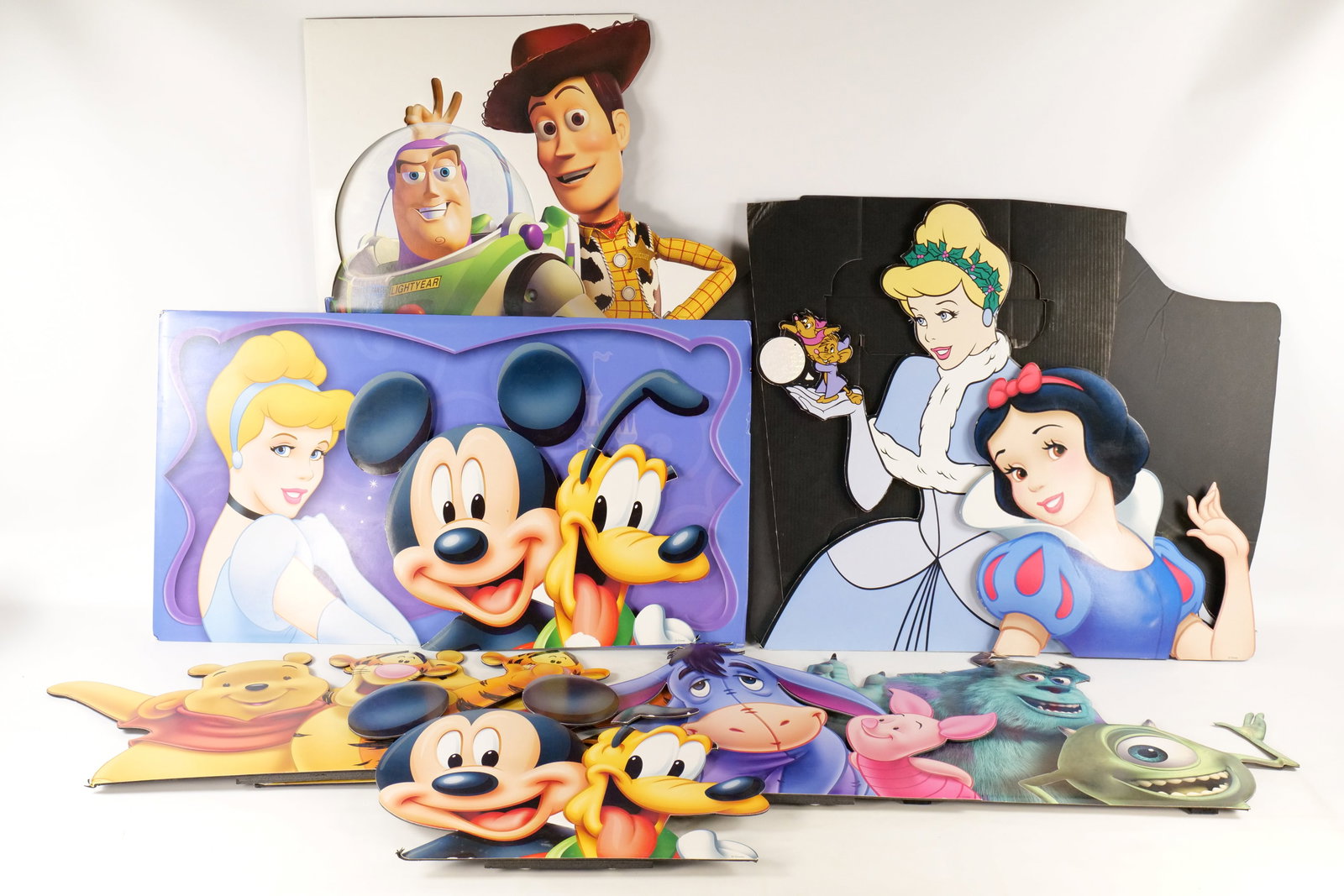 Lot of Disney Store Cardboard Cutouts: Lot of Disney Store Cardboard Cutouts. Including Cinderella Standee, Cinderella Banner, Sully and Mike, Woody and Buzz, Mickey and Pluto, Pooh and Tigger, and More. Some pieces are missing some body p